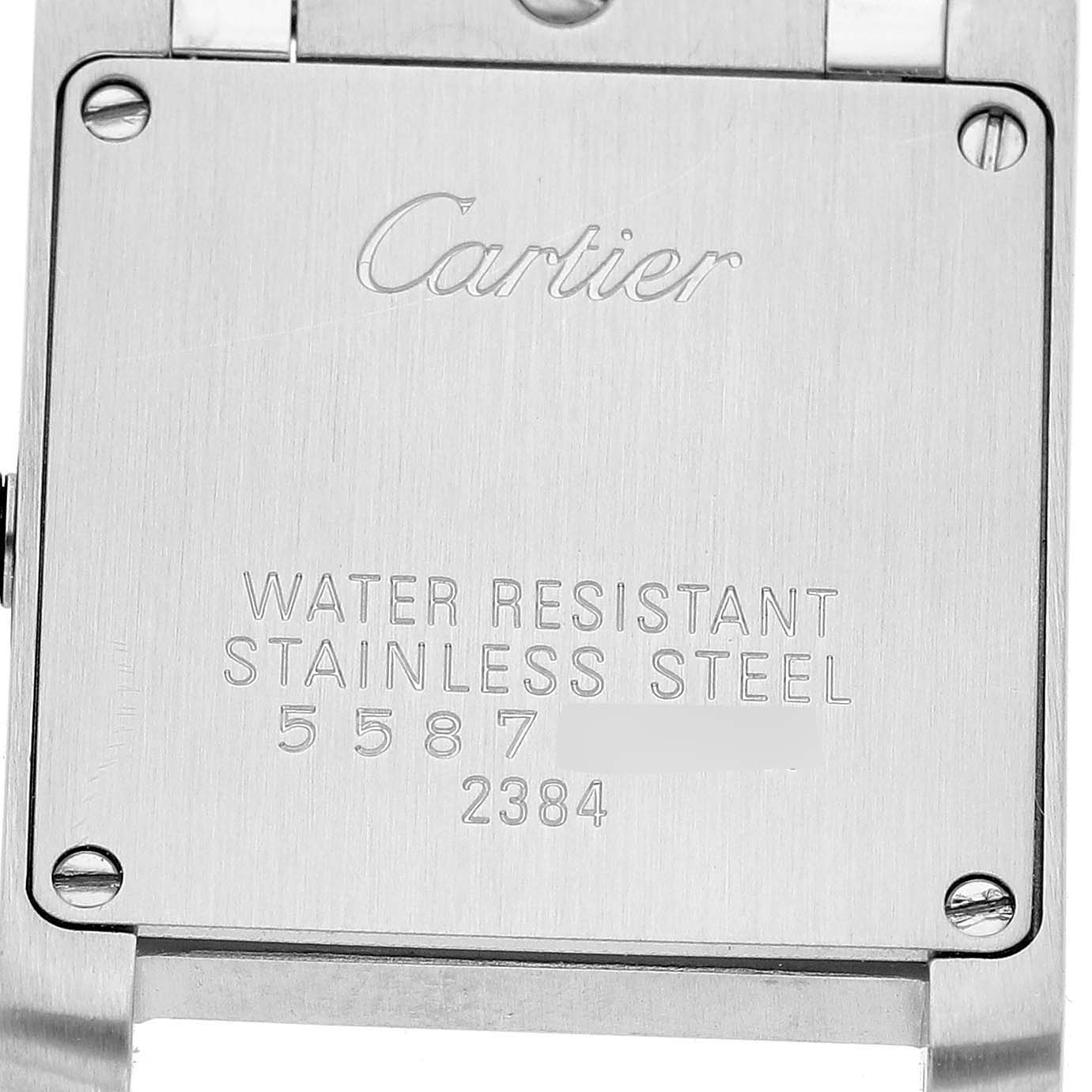 The image shows the back of the Cartier Tank Française watch, highlighting its stainless steel casing and engraved details.