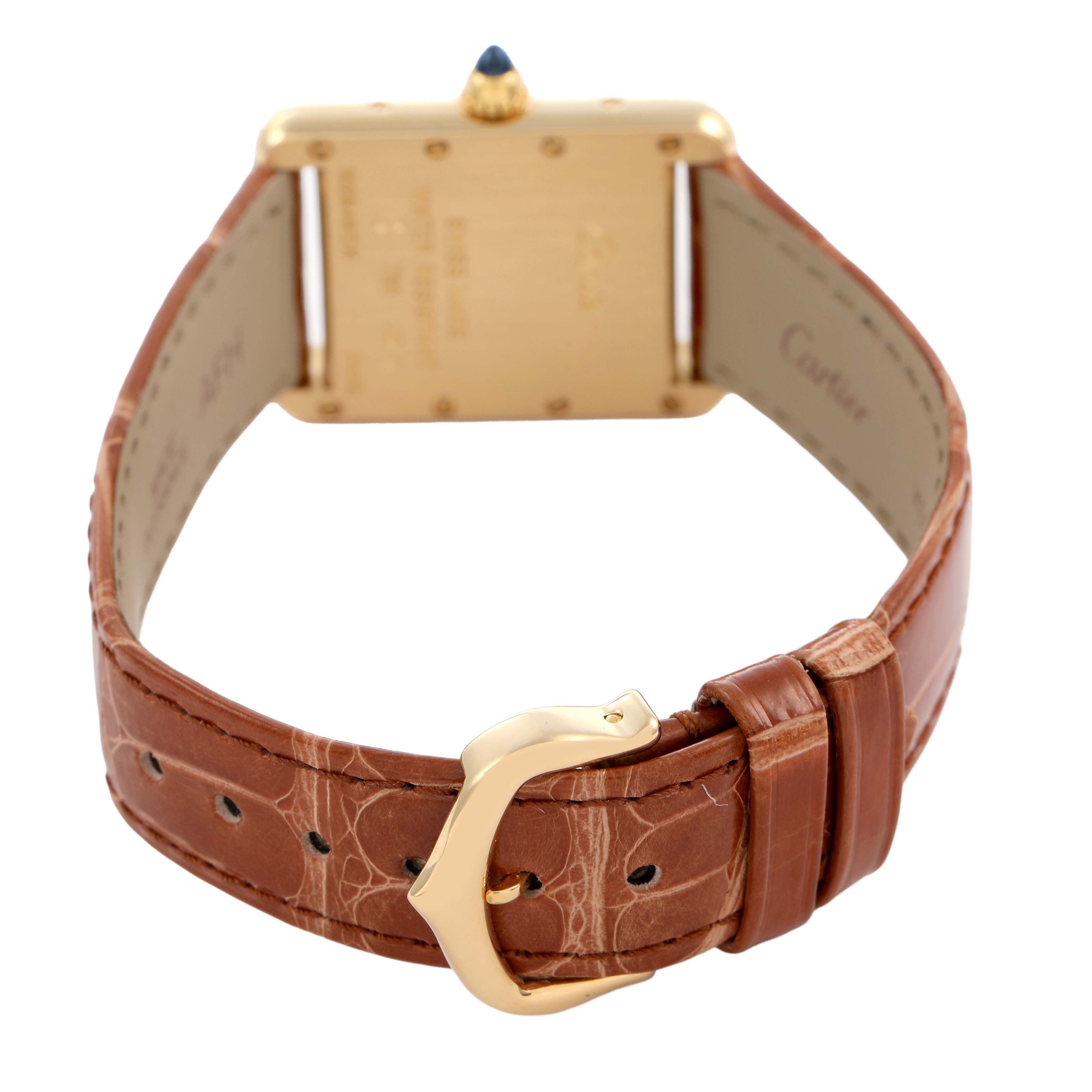 The image shows the back view of a Cartier Tank Louis W1529856 Women's Yellow Gold Silver Dial watch, highlighting its gold case, crown, and brown leather strap with a buckle.