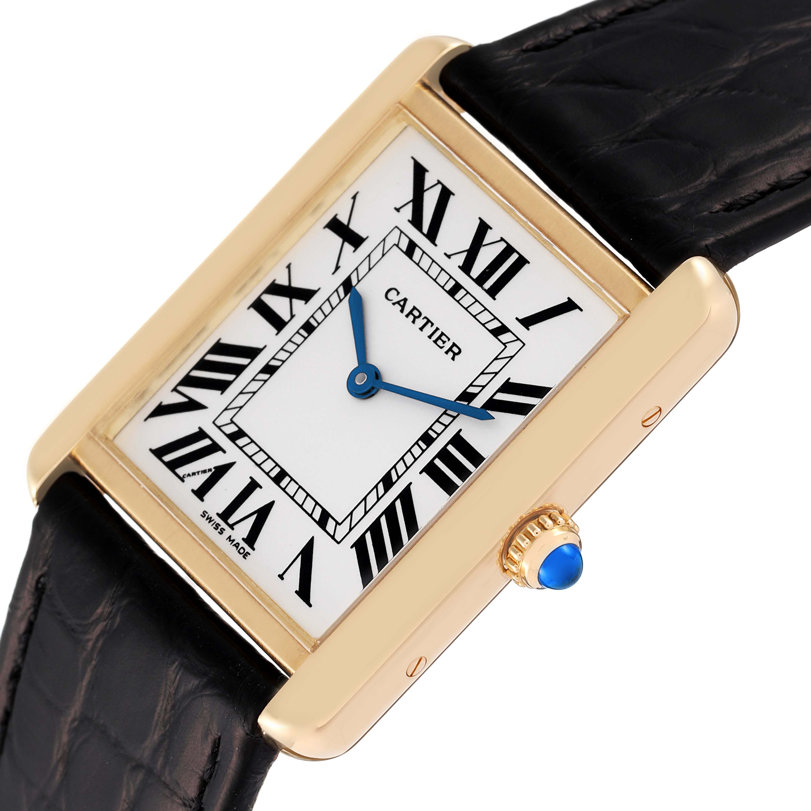The image shows a close-up of a Cartier Tank Solo W5200004 Men
s Yellow Gold Silver Dial W5200004 Men
s Yellow Gold Silver Dial watch, highlighting its face, Roman numerals, blue hands, and the crown with a blue cabochon.