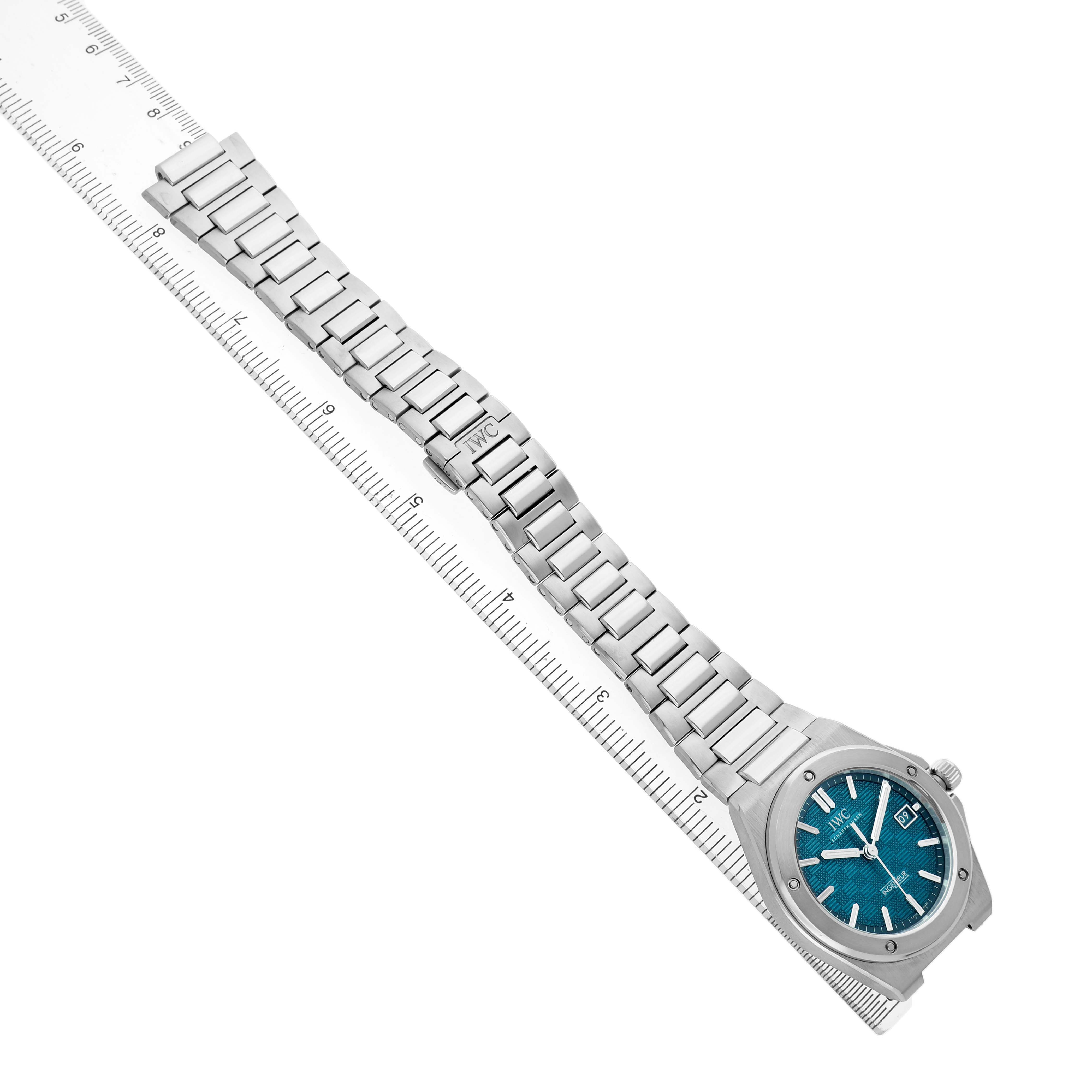 The IWC Ingenieur IW328903 Men's Stainless Steel Blue Dial watch is shown flat with its metal bracelet extended and a ruler for scale.