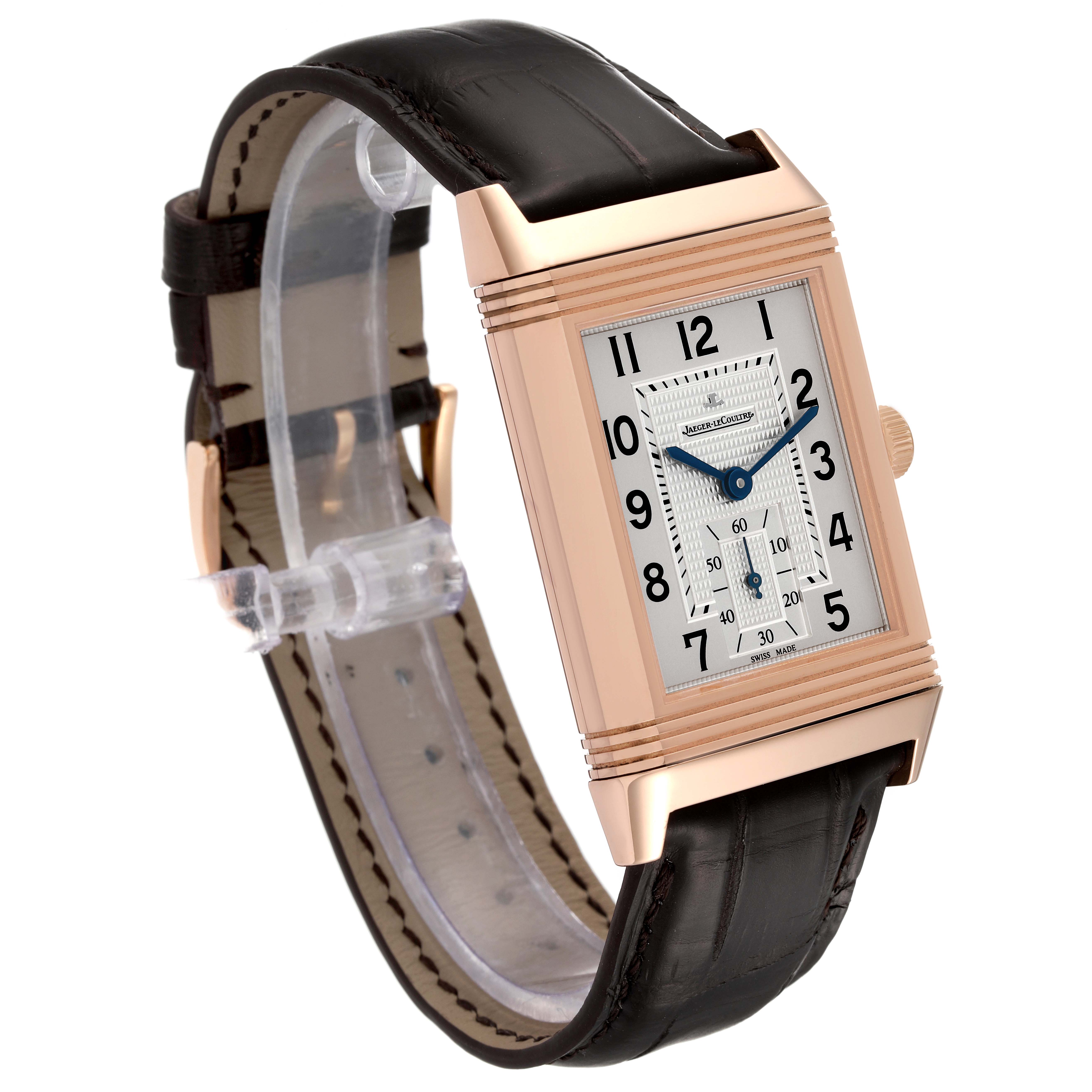 The image shows a side-angle view of the Jaeger-LeCoultre Reverso watch, highlighting its rectangular face, leather strap, and crown.