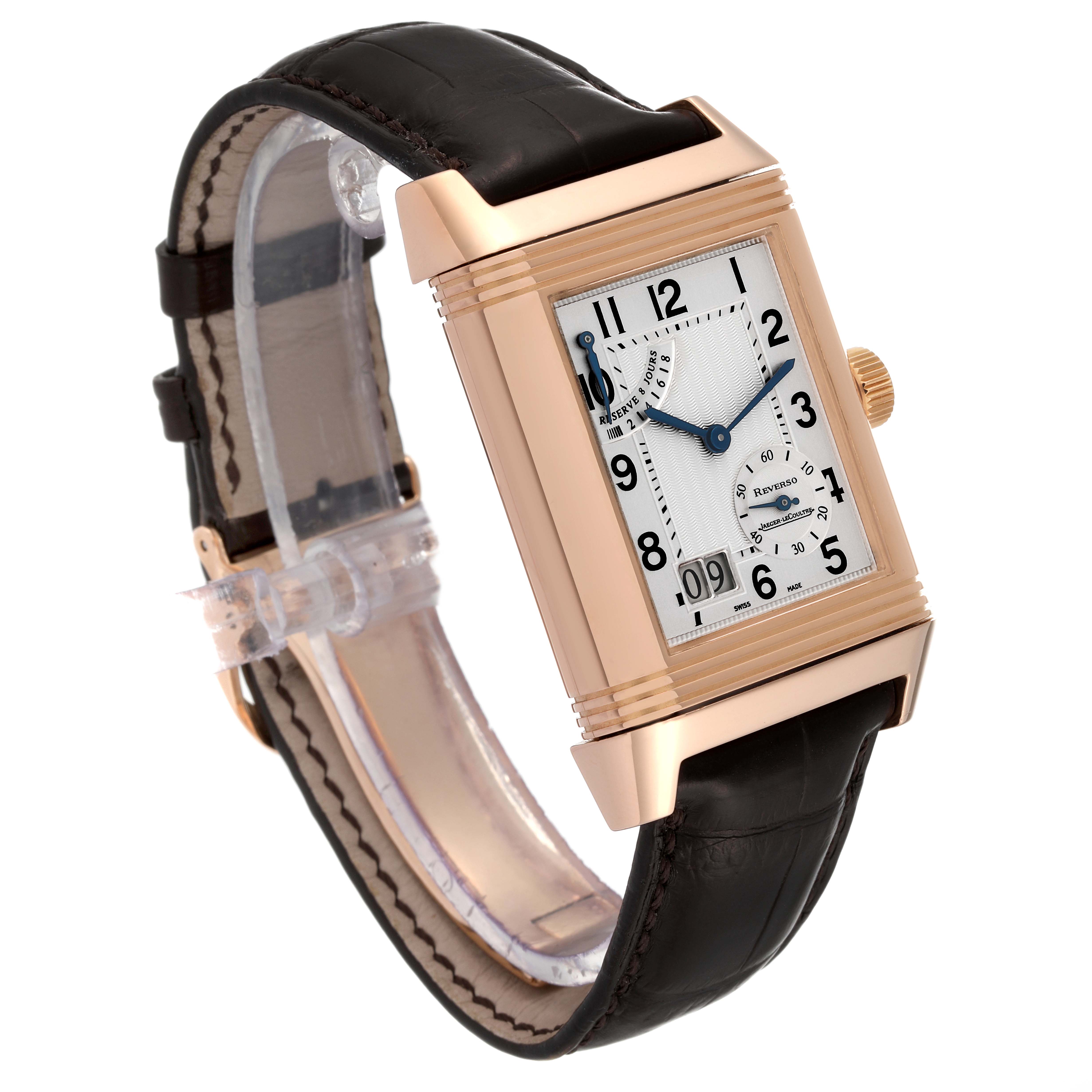 The image shows a Jaeger-LeCoultre Reverso watch at a slight angle, highlighting its rectangular face, crown, and leather strap.