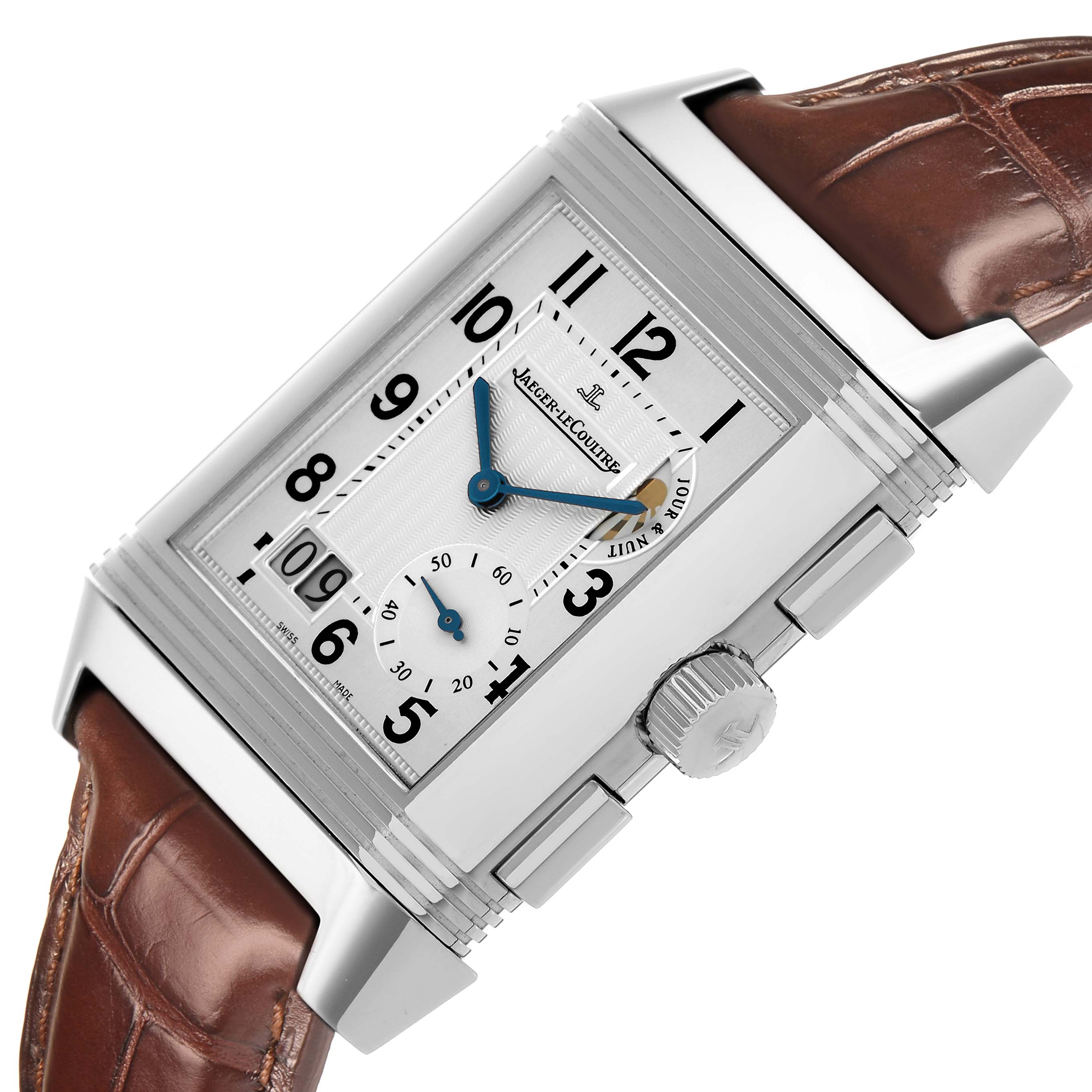 The Jaeger LeCoultre Reverso Q3028420 Men's Stainless Steel Silver Dial watch is shown at a tilted angle, displaying the dial, case, crown, and brown leather strap.