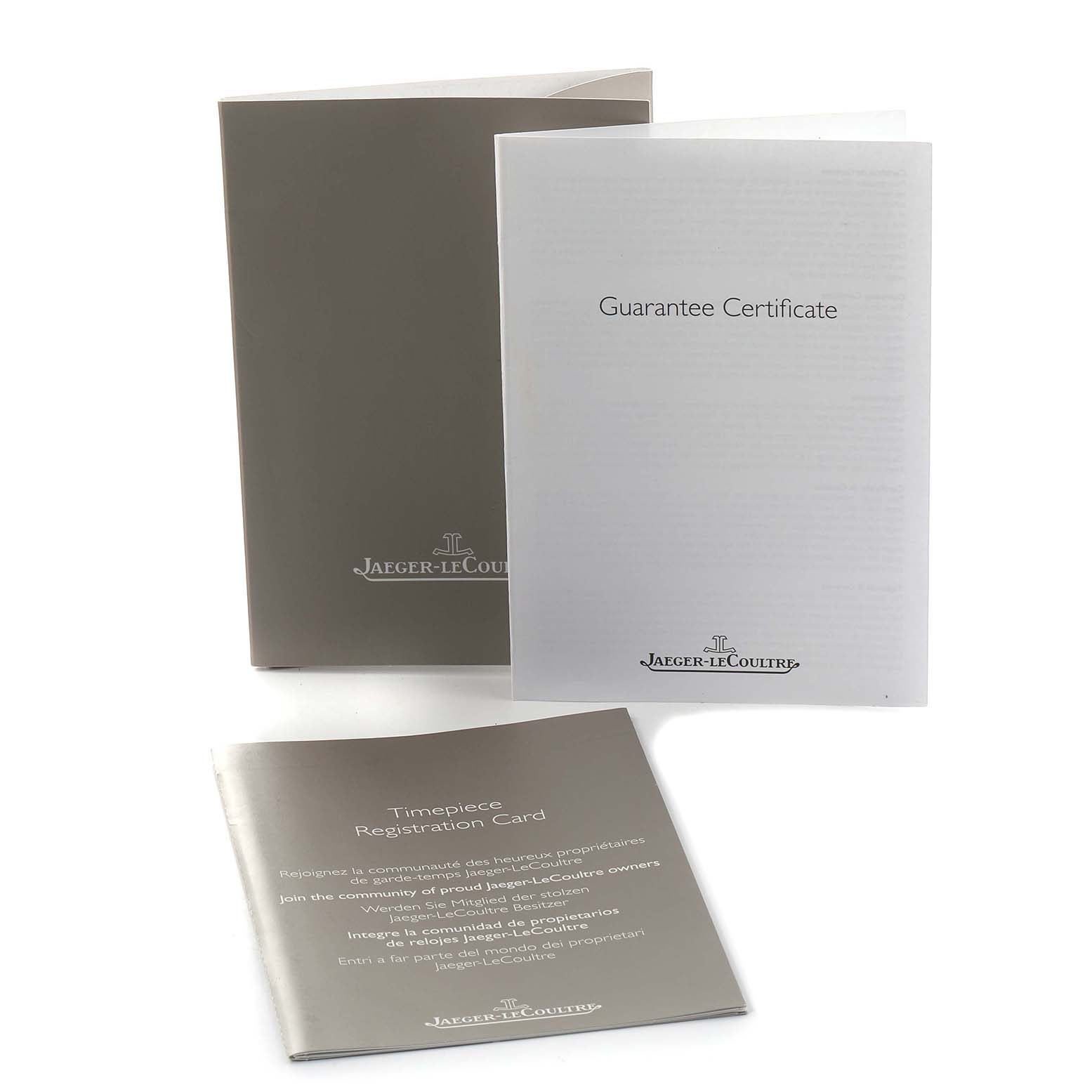 The image shows Jaeger-LeCoultre Reverso packaging, including a box, guarantee certificate, and registration card.