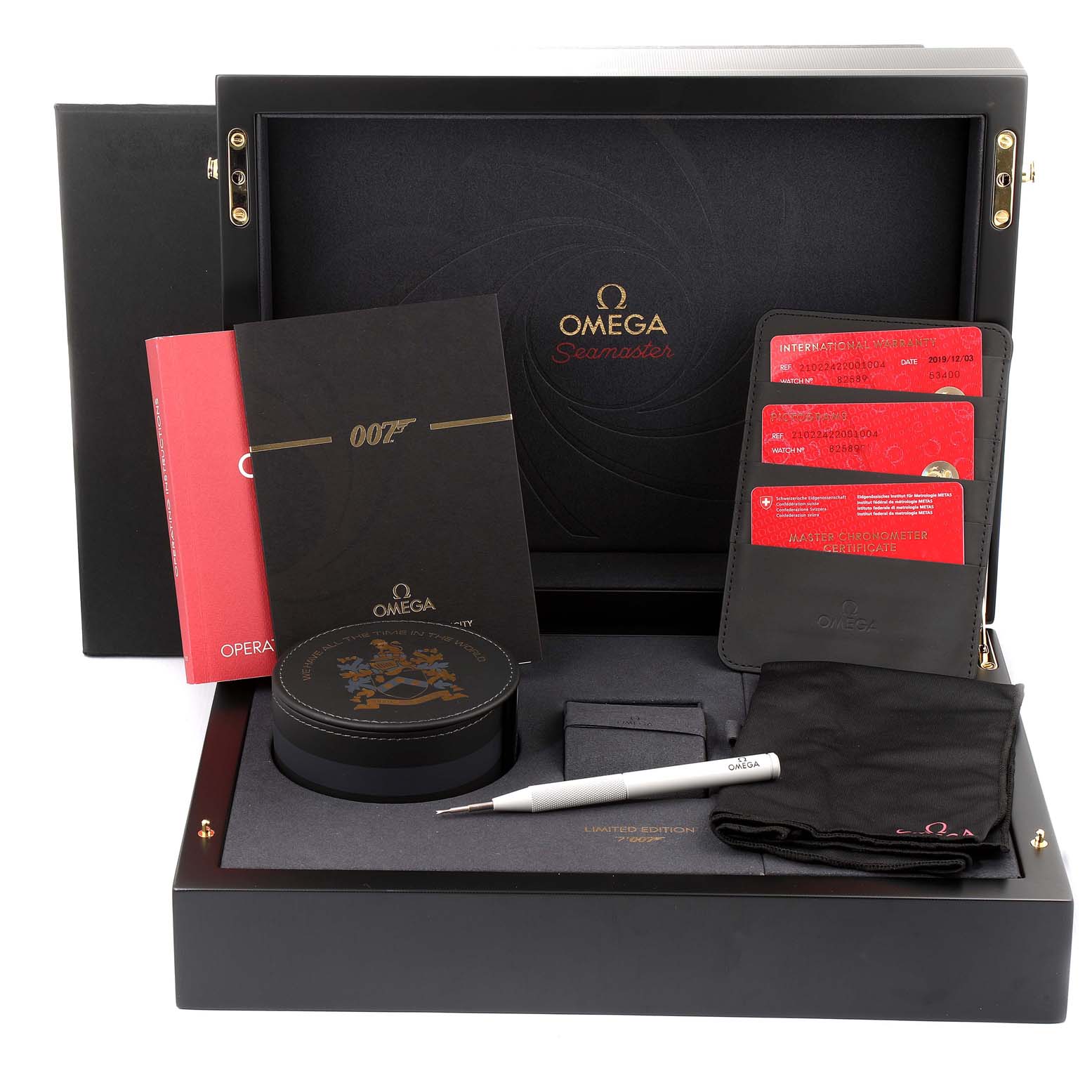 The image shows an Omega Seamaster 210.22.42.20.01.004 Men's Stainless Steel Black Dial 210.22.42.20.01.004 Men's Stainless Steel Black Dial watch box set with accessories, including a tool, booklets, cards, and a watch case from a front angle.