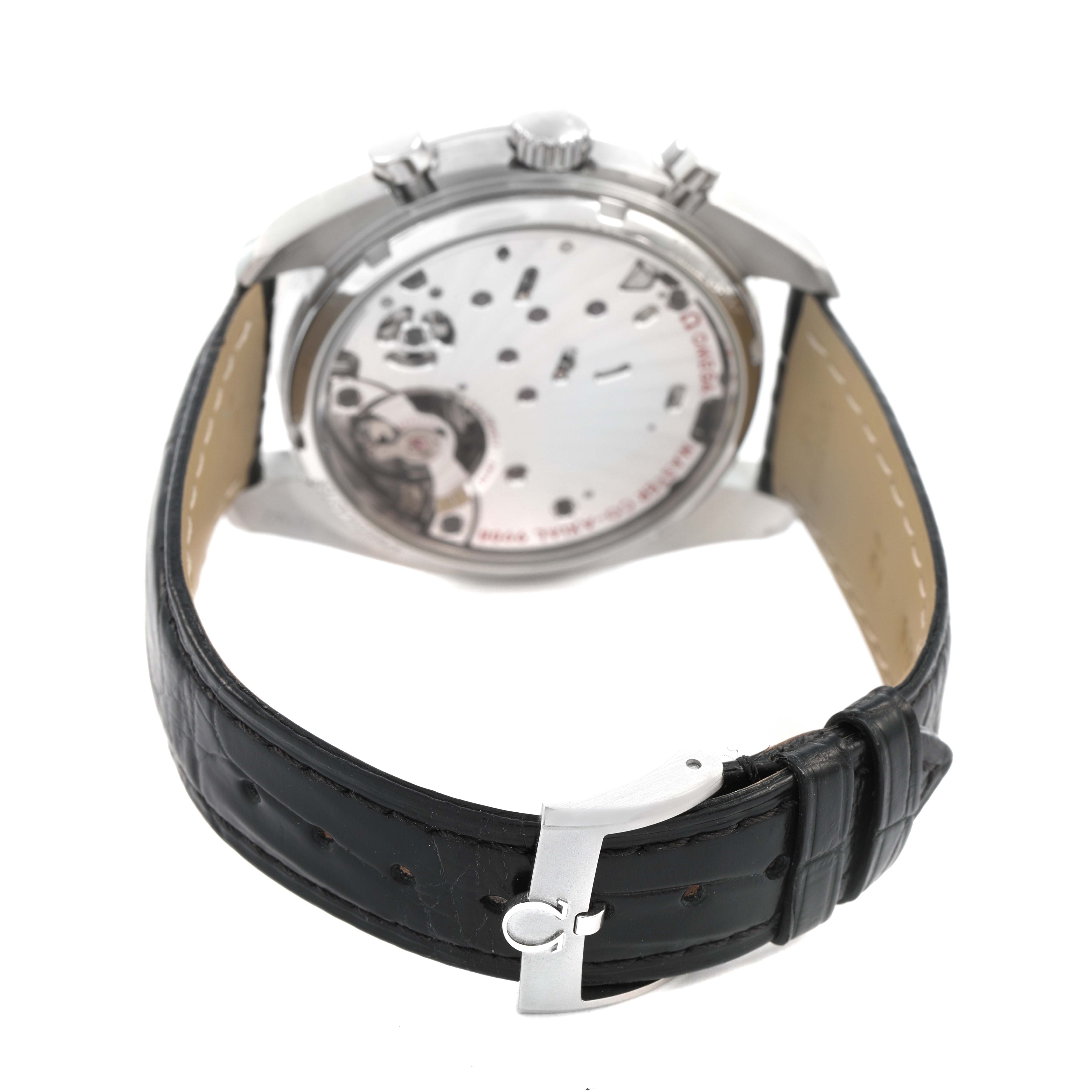 The image shows the back of an Omega Speedmaster 329.33.43.51.02.001 Men's Stainless Steel Silver Dial, highlighting the movement through a transparent case back and the black leather strap.