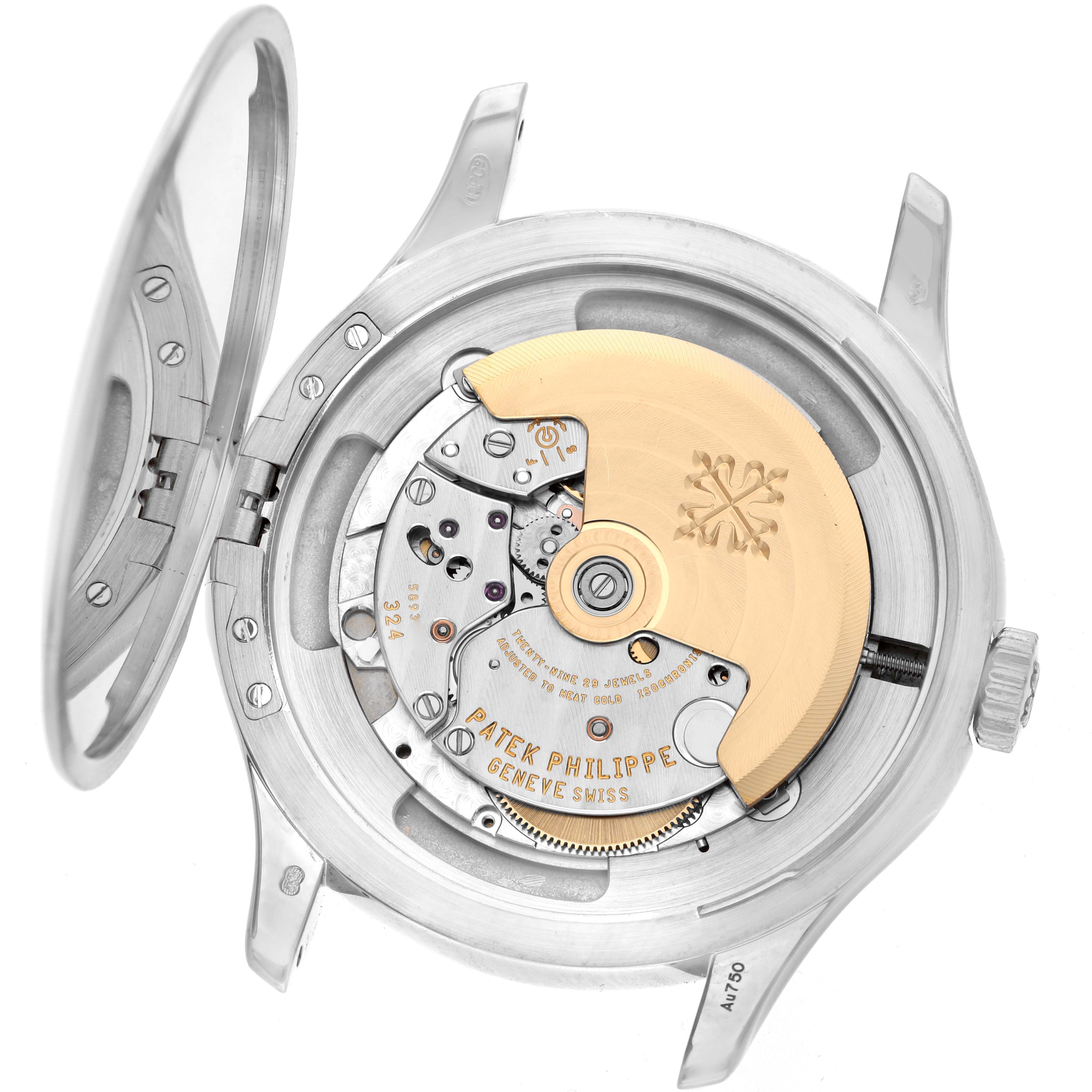 The image shows the movement and case back of a Patek Philippe Calatrava 5227G Men
s White Gold Black Dial watch, viewed from the back with an open case.