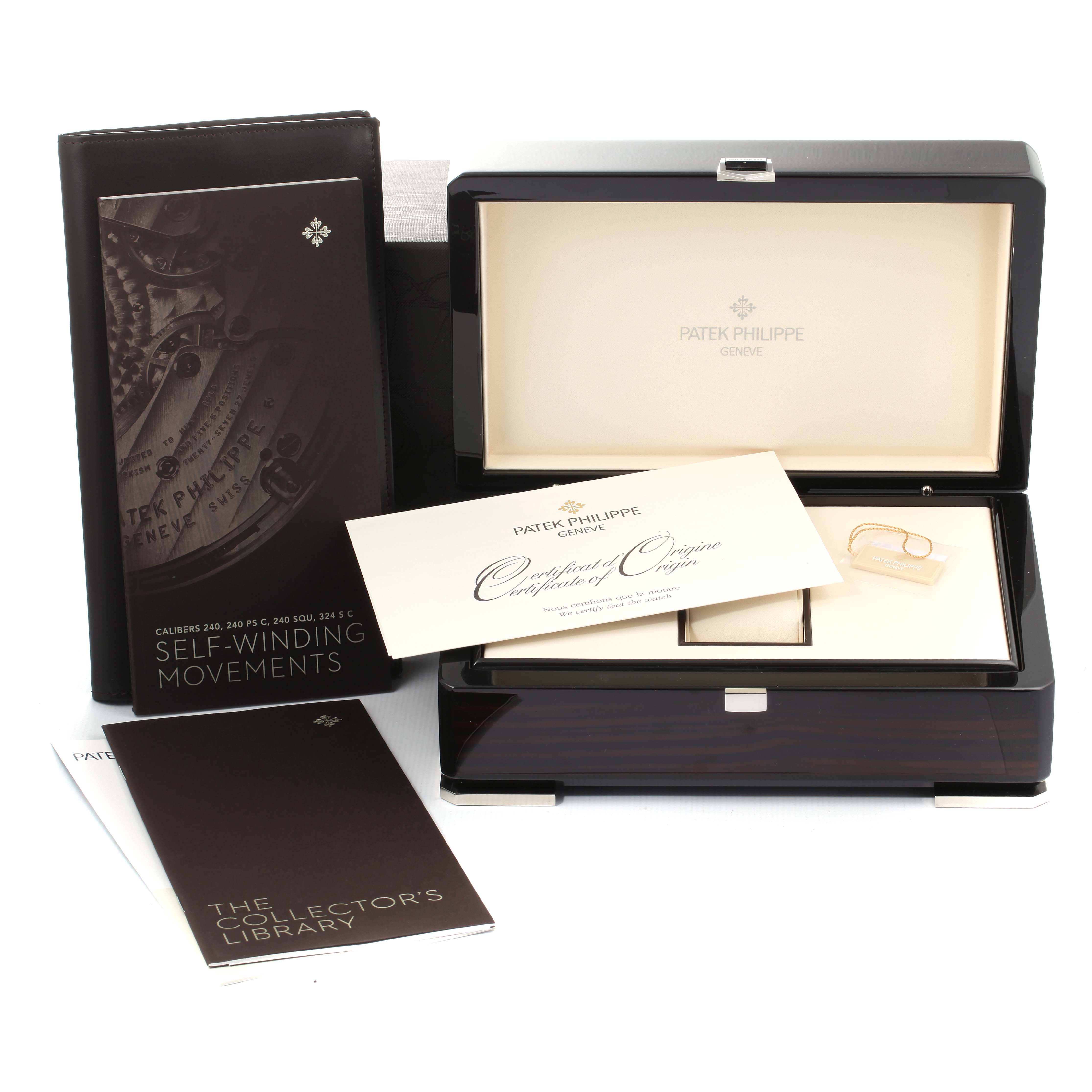 This image shows the packaging and accessories of a Patek Philippe Nautilus 7018/1A-001 Women's Stainless Steel Silver Dial 7018/1A-001 Women's Stainless Steel Silver Dial watch, including the box, certificate, and booklets.