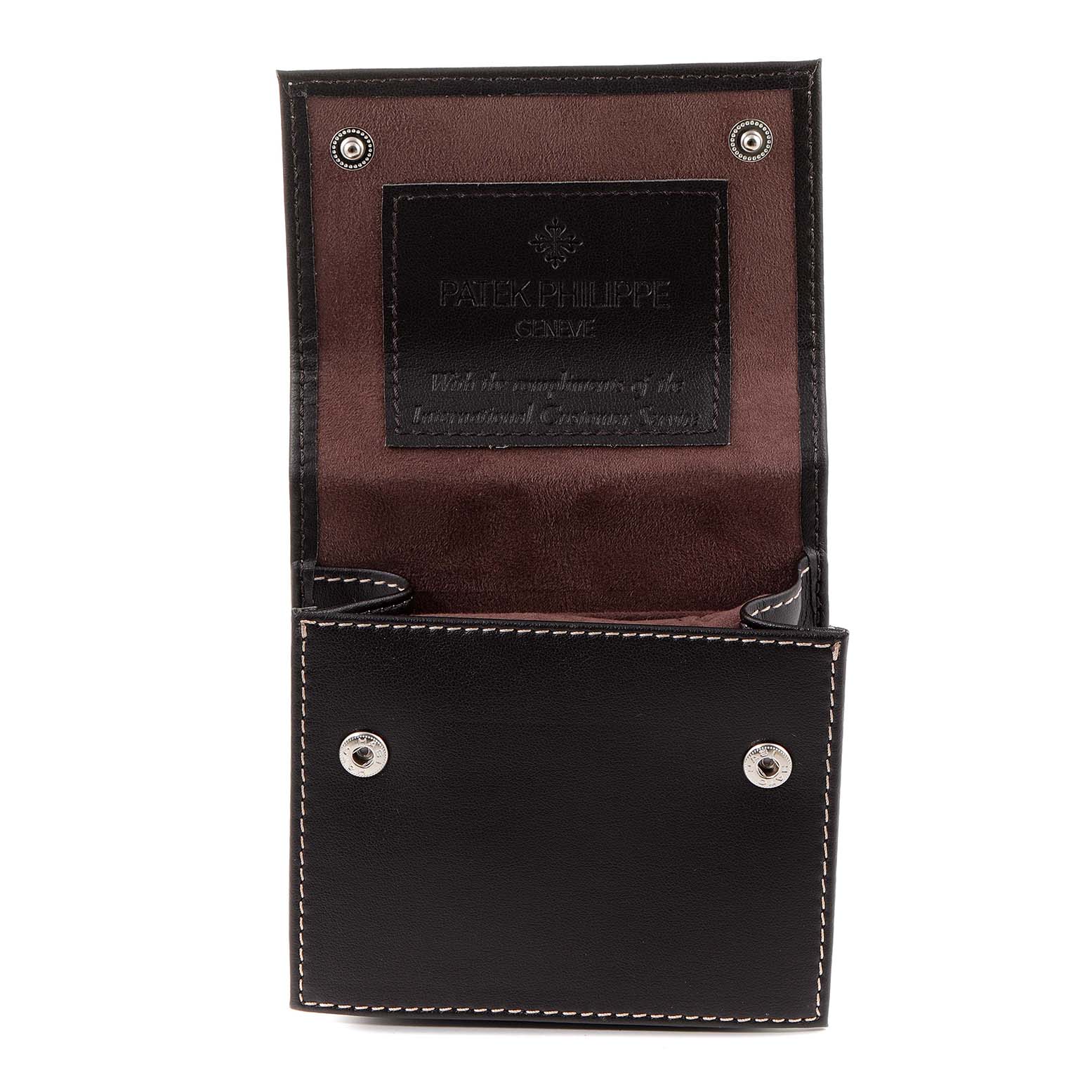 The image shows an open leather case for a Patek Philippe Twenty-4 4910-10A-012 Women's Stainless Steel Blue Dial 4910-10A-012 Women's Stainless Steel Blue Dial watch, featuring black exterior and brown interior.