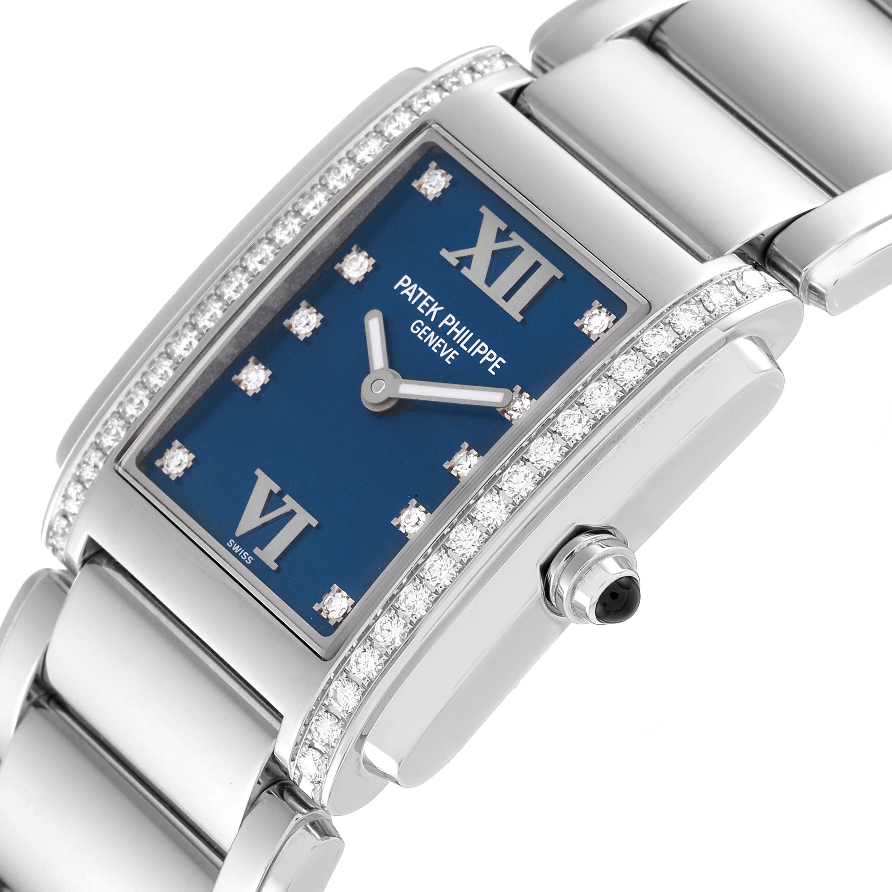 The image shows a close-up angle of the Patek Philippe Twenty-4 4910-10A-012 Women
s Stainless Steel Blue Dial 4910-10A-012 Women
s Stainless Steel Blue Dial watch, highlighting its blue dial, diamond-set bezel, and part of the bracelet.