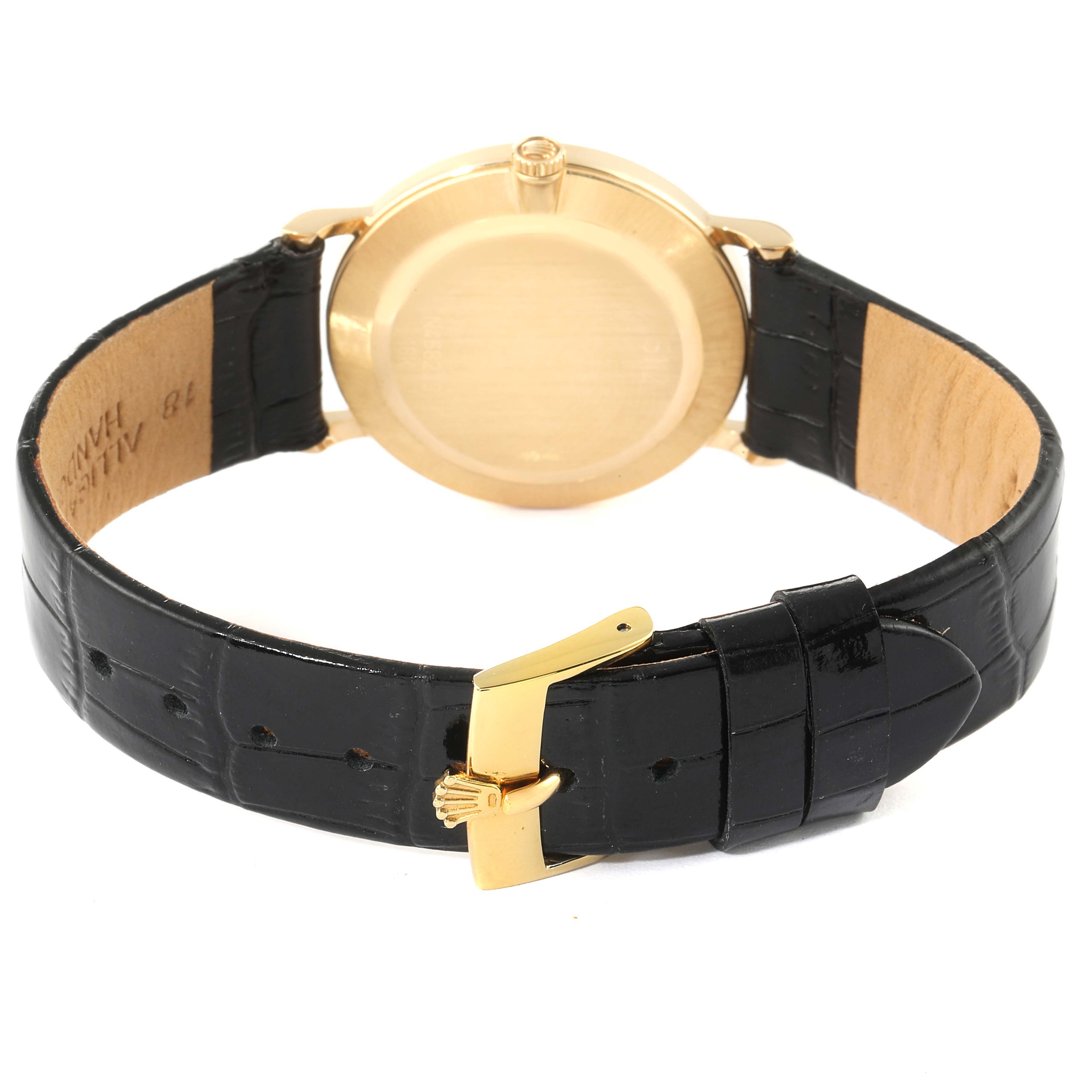 The image shows the rear view of a Rolex Cellini 5112 Men's Yellow Gold Champagne Dial 5112 Men's Yellow Gold Champagne Dial watch, highlighting the yellow-gold case back and the black leather strap with a gold buckle.