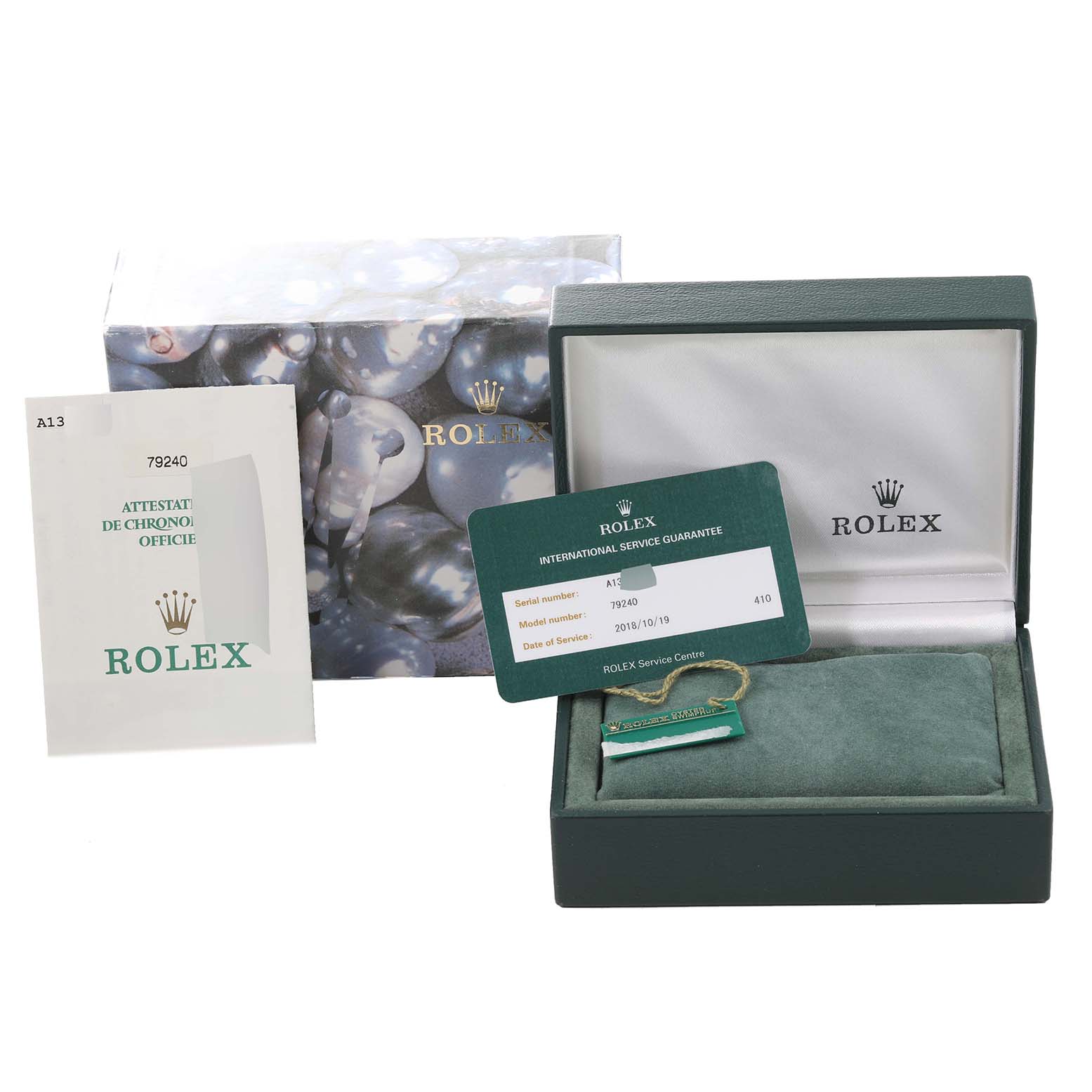The image shows the packaging, international service guarantee card, instruction booklet, and box for a Rolex Date 79240 Women's Stainless Steel Black Dial 79240 Women's Stainless Steel Black Dial model watch.