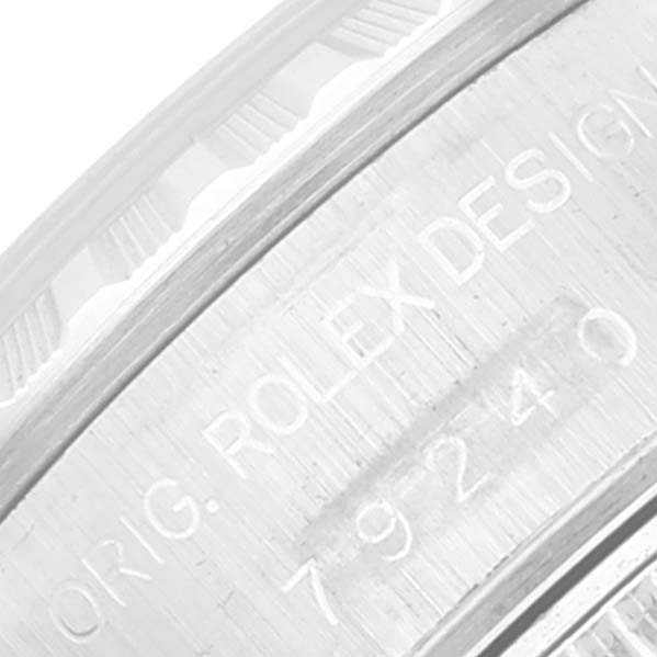 The image shows an engraved part of the Rolex Date 79240 Women's Stainless Steel Black Dial 79240 Women's Stainless Steel Black Dial model watch casing.