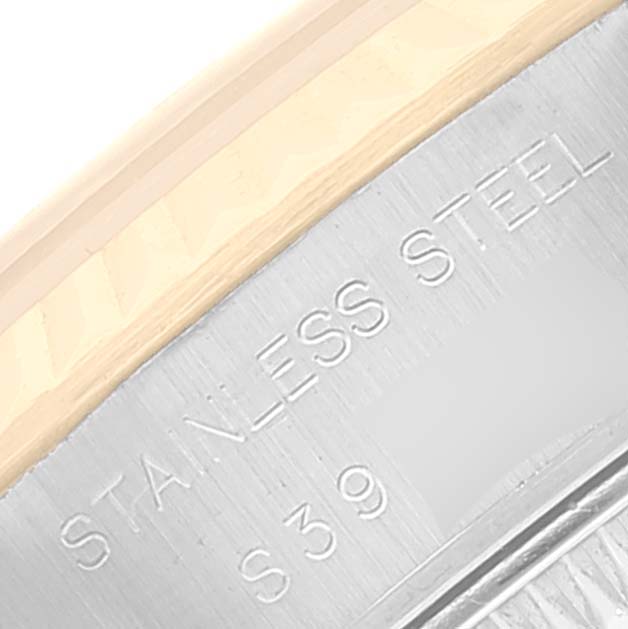 The image shows a close-up of the stainless steel part of a Rolex Datejust 69173 Women's Steel and Gold (two tone) Champagne Dial 69173 Women's Steel and Gold (two tone) Champagne Dial watch, displaying engraved text.