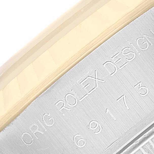This image shows a close-up angle of the engraved casing on a Rolex Datejust 69173 Women's Steel and Gold (two tone) Champagne Dial 69173 Women's Steel and Gold (two tone) Champagne Dial watch.