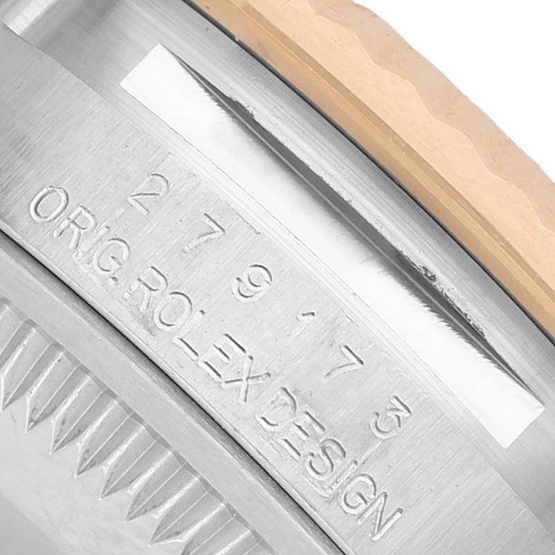 The image shows a close-up of the Rolex Datejust 279173 Women's Steel and Gold (two tone) Champagne Dial's case side, highlighting the engraved serial numbers and design details.