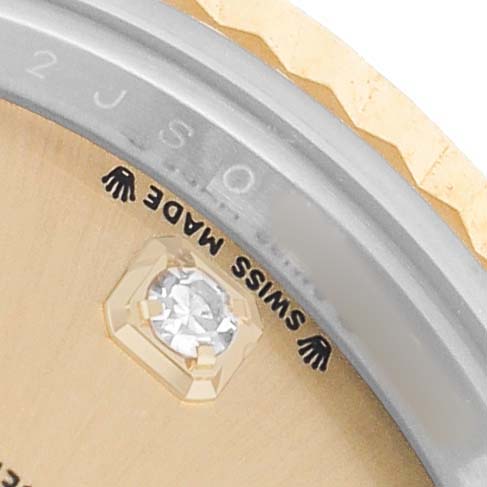 The image shows a close-up of the dial edge and bezel of a Rolex Datejust 279173 Women's Steel and Gold (two tone) Champagne Dial, featuring "SWISS MADE" text and part of a diamond marker.