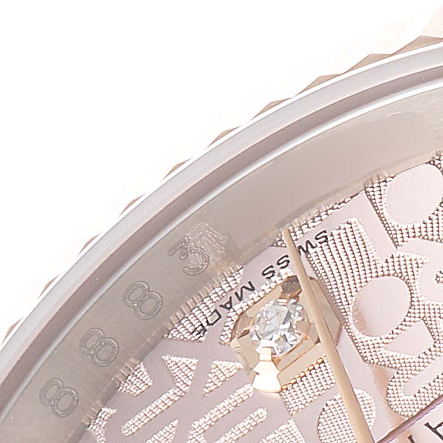 This close-up image shows the dial, hands, and part of the bezel of the Rolex Datejust 116231 Men's Steel and Gold (two tone) Pink Dial 116231 Men's Steel and Gold (two tone) Pink Dial watch.