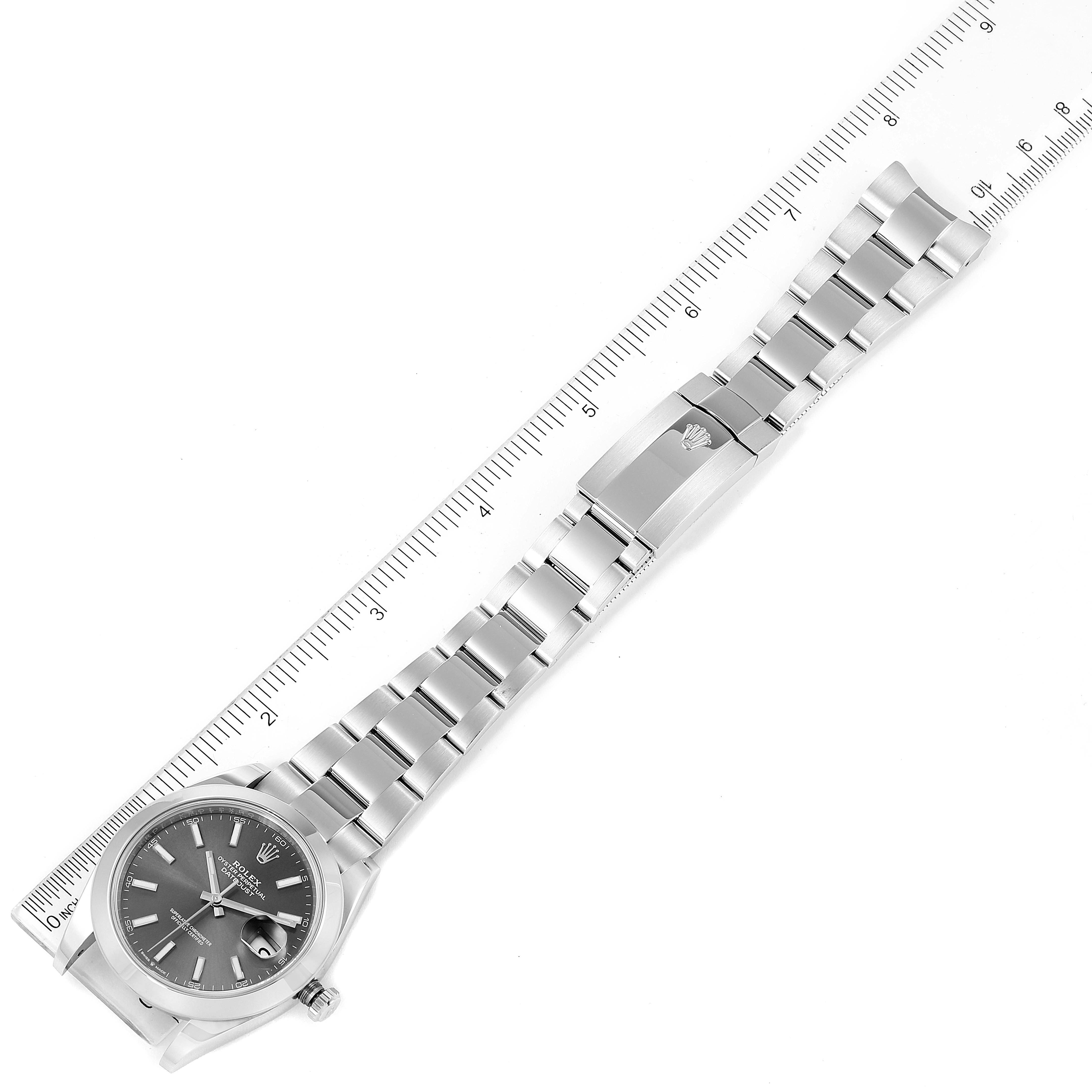 This image shows a Rolex Datejust 41 126300 Men's Stainless Steel Grey Dial 126300 Men's Stainless Steel Grey Dial watch laid flat with the dial, strap, and clasp visible, alongside a ruler for size reference.