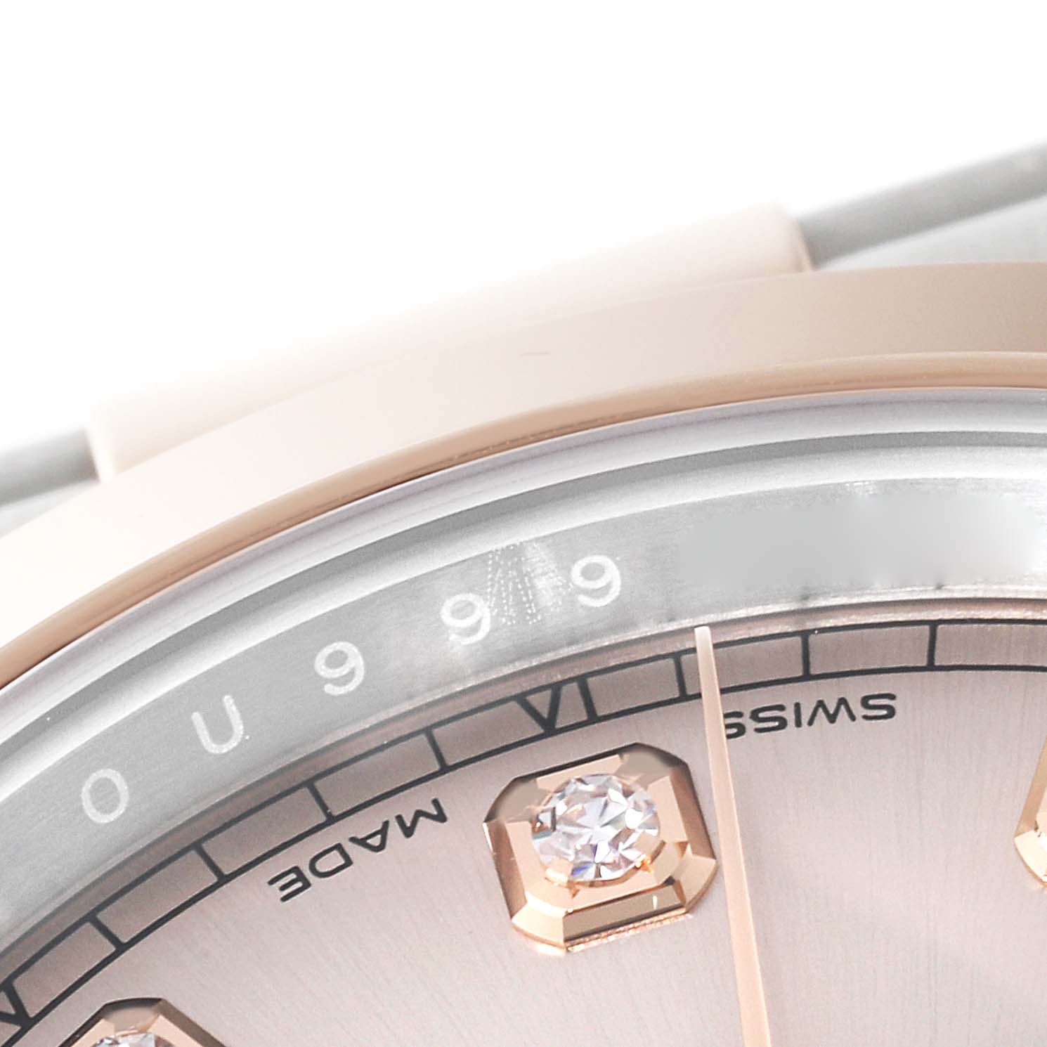 This close-up image of a Rolex Datejust 41 126301 Men's Steel and Gold (two tone) Pink Dial 126301 Men's Steel and Gold (two tone) Pink Dial shows part of its dial, diamonds, and indices from an angled side view.