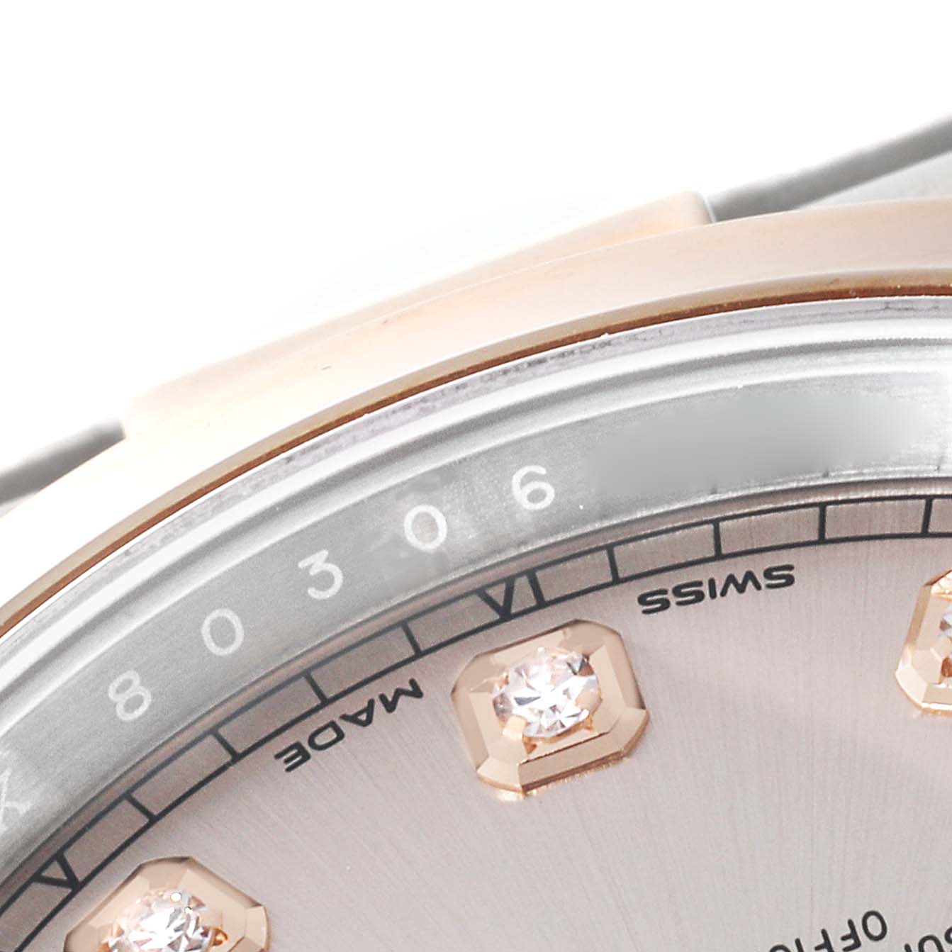 This close-up of the Rolex Datejust 41 126301 Men's Steel and Gold (two tone) Pink Dial 126301 Men's Steel and Gold (two tone) Pink Dial shows part of the dial, diamonds, and part of the bezel.