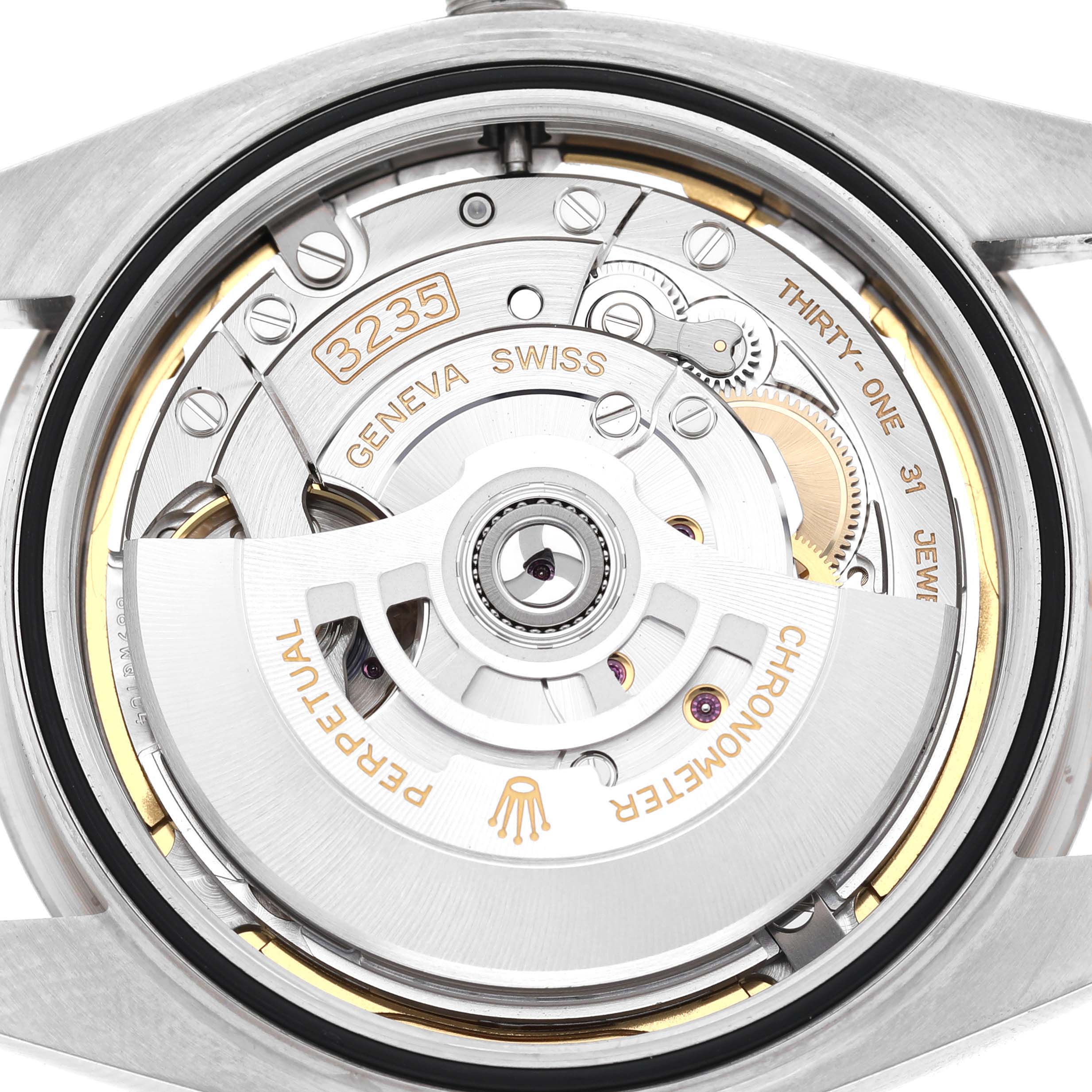 The image shows the movement of the Rolex Datejust 41 126334 Men's Stainless Steel Green Dial, highlighting the rotor and intricate mechanical components.