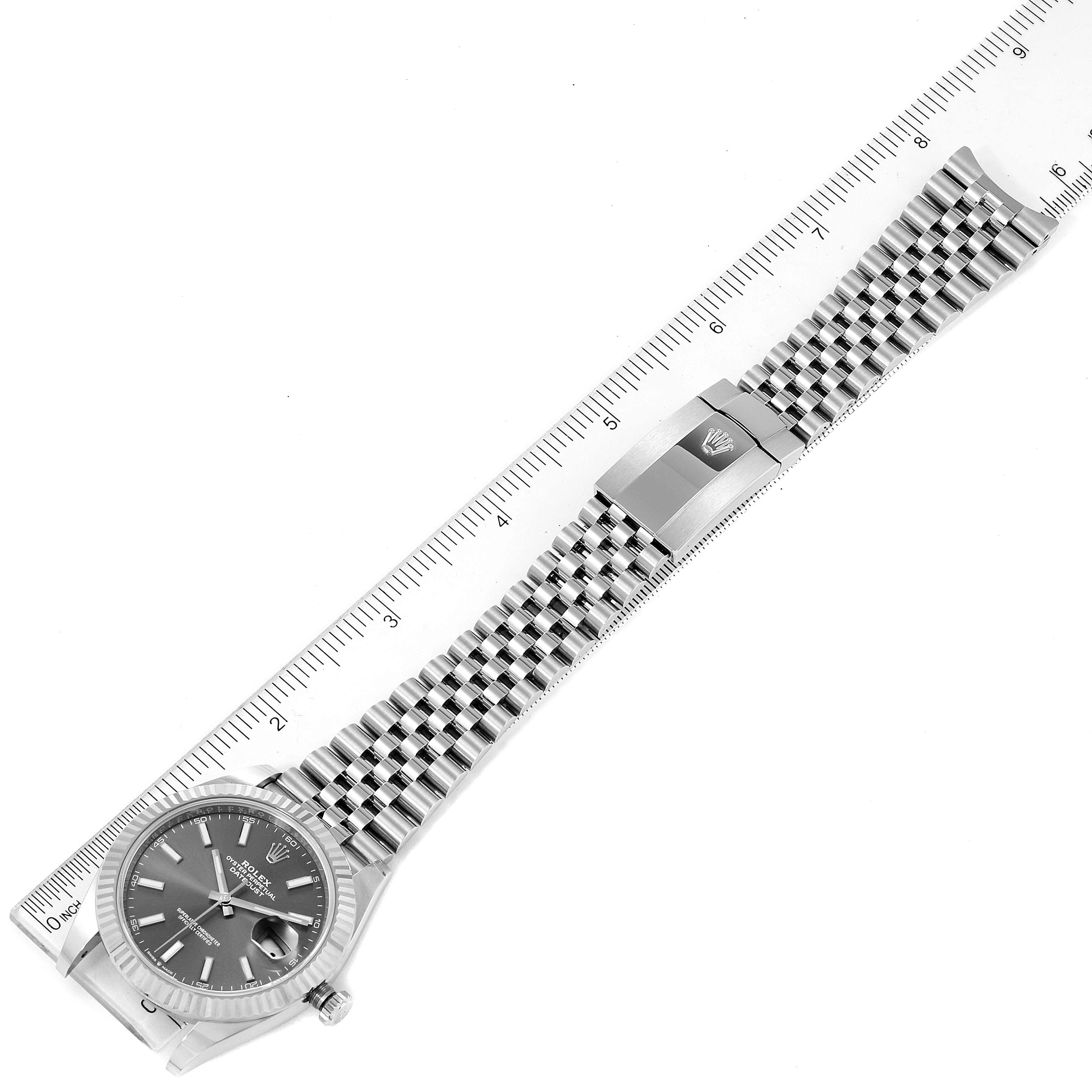 The image shows a Rolex Datejust 41 126334 Men's Stainless Steel Grey Dial 126334 Men's Stainless Steel Grey Dial model watch laid flat with its face and bracelet fully extended next to a ruler.