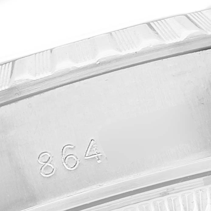 The image shows a close-up of the serial number engraved on the side of the bezel of a Rolex Datejust 69240 Women's Stainless Steel Black Dial 69240 Women's Stainless Steel Black Dial watch.