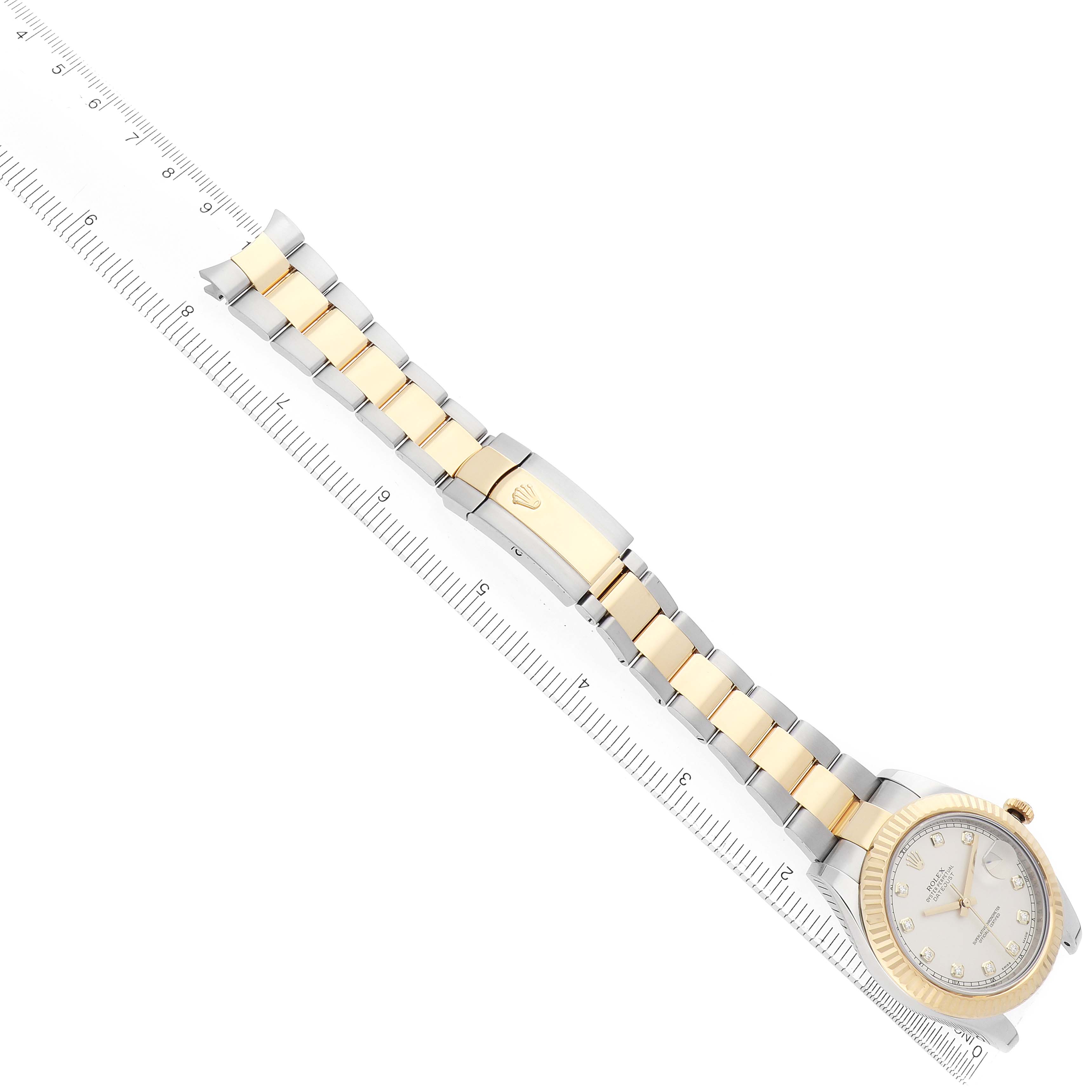 The Rolex Datejust 41 116333 Men
s Steel and Gold (two tone) Silver Dial is shown from a top-down angle, featuring its bracelet, clasp, and face beside a ruler for scale.