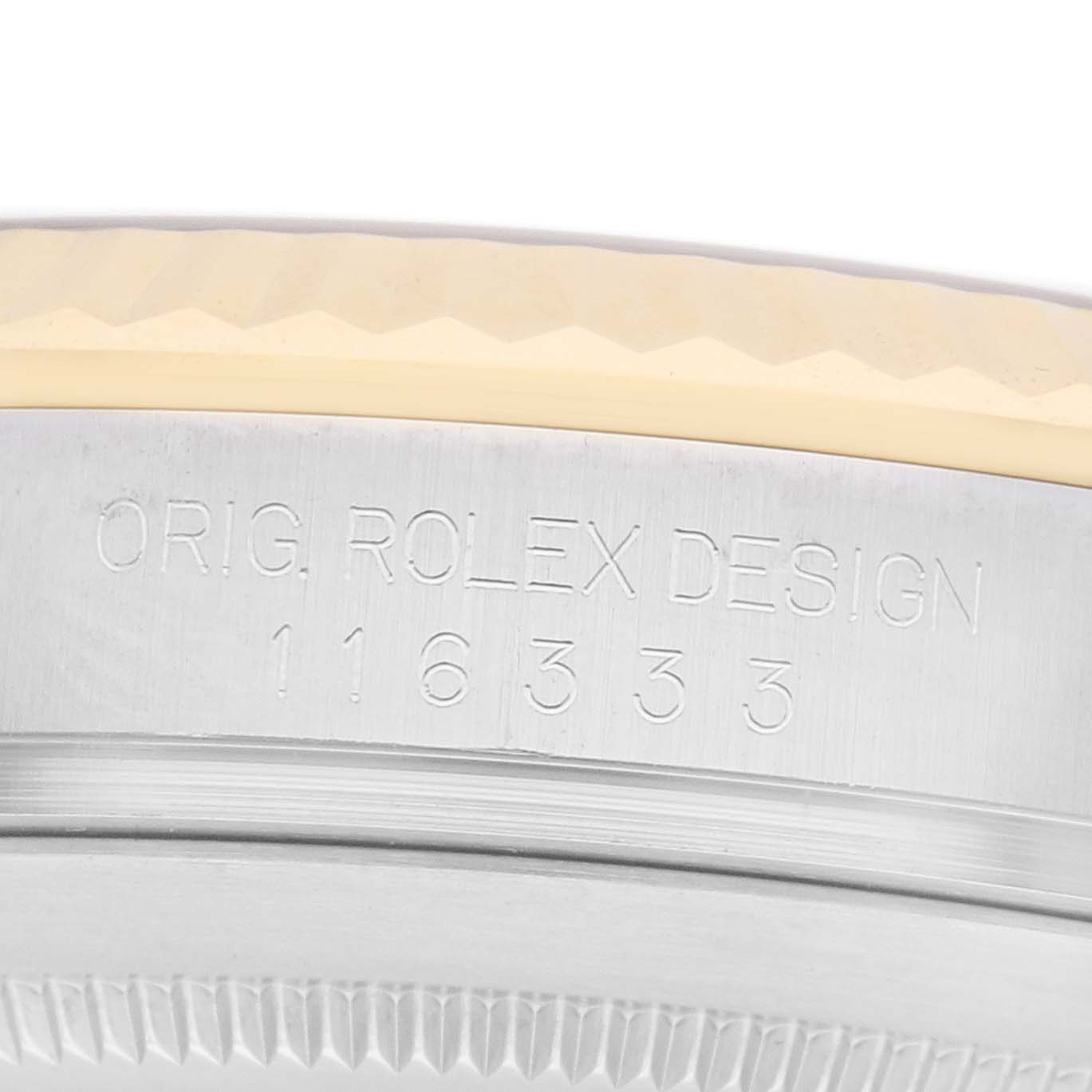 The image shows a close-up of the side view of a Rolex Datejust 41 116333 Men
s Steel and Gold (two tone) Silver Dial watch bezel with engraving details.