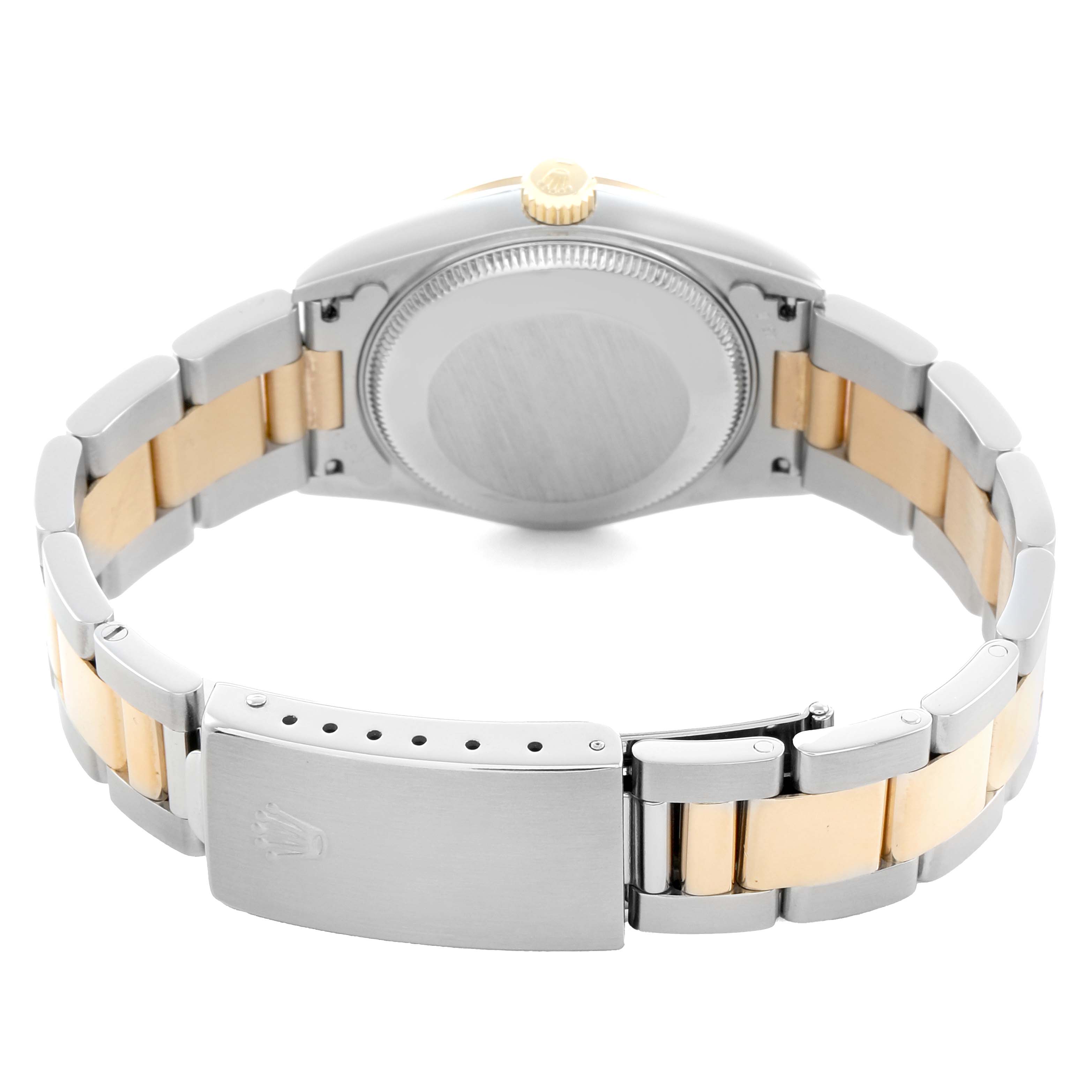 The image shows the back case, crown, and two-tone bracelet of a Rolex Datejust 68243 Women
s Steel and Gold (two tone) White Dial watch, viewed from the rear angle.