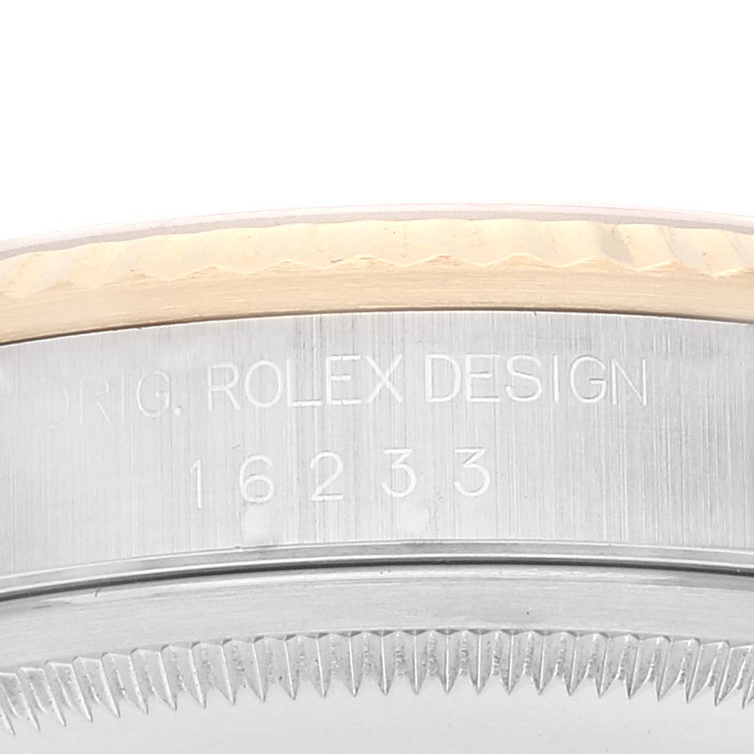 This image shows a close-up of the side of a Rolex Datejust 16233 Men's Steel and Gold (two tone) Silver Dial 16233 Men's Steel and Gold (two tone) Silver Dial watch case with the model number 16233 engraved.