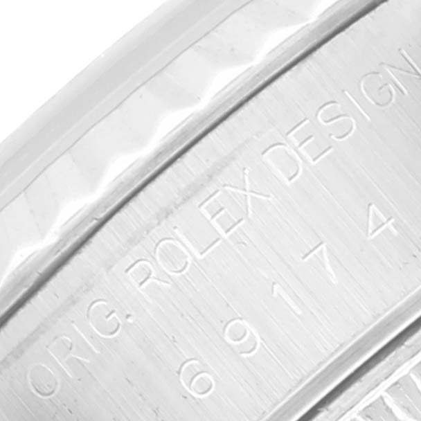 This close-up image shows the engraved case side of the Rolex Datejust 69174 Women's Stainless Steel Mother of Pearl Dial 69174 Women's Stainless Steel Mother of Pearl Dial watch with the model and design number.