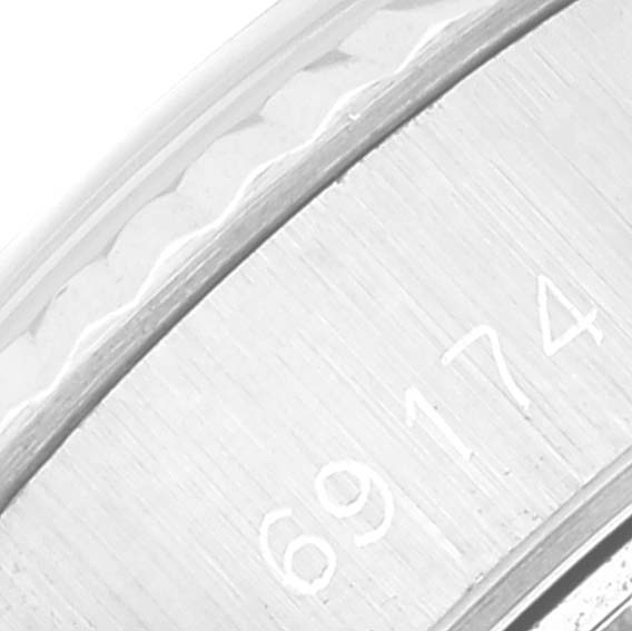 This close-up image of a Rolex Datejust 69174 Women's Stainless Steel Silver Dial 69174 Women's Stainless Steel Silver Dial watch shows a partial view of the case with the model number 69174 engraved on it.