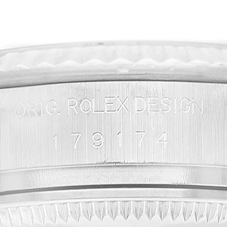 This is a close-up image of a Rolex Datejust 179174 Women's Stainless Steel White Dial 179174 Women's Stainless Steel White Dial watch's case showing the model number and "ORIG. ROLEX DESIGN" engraving.
