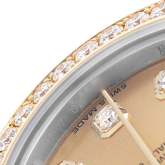 The Rolex Datejust 179383 Women's Steel and Gold (two tone) Champagne Dial watch is shown at a close-up angle, highlighting the diamond bezel and part of the dial with a gold hour marker.
