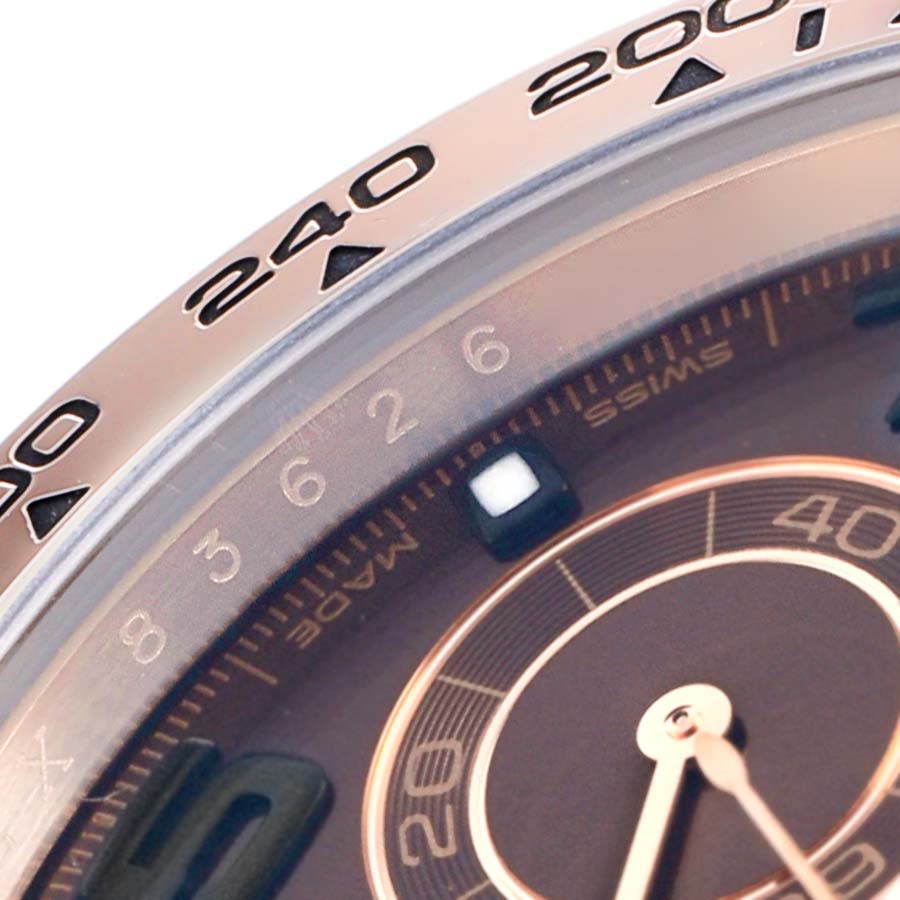 The image shows a close-up of the Rolex Daytona 116505 Men
s Rose Gold Brown Dial
s dial and bezel, highlighting the tachymetric scale and sub-dial.