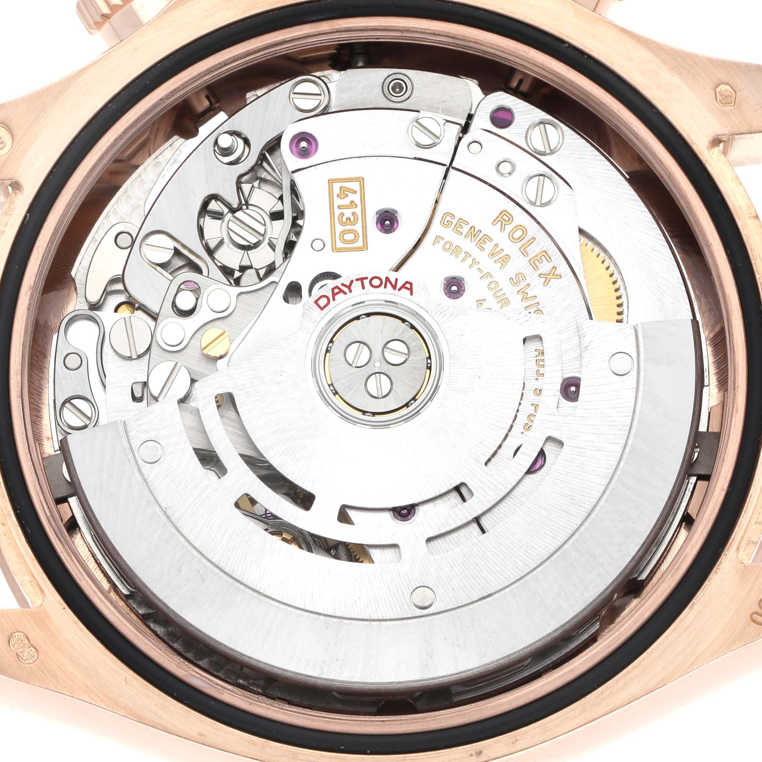 The image shows the Rolex Daytona 116505 Men
s Rose Gold Brown Dial movement viewed from the back, highlighting the intricate gears and rotor.