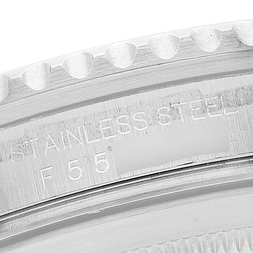 The image shows a close-up of the back case edge of a Rolex GMT-Master 16710 Men
s Stainless Steel Black Dial 16710 Men
s Stainless Steel Black Dial, highlighting the stainless steel text and serial number.