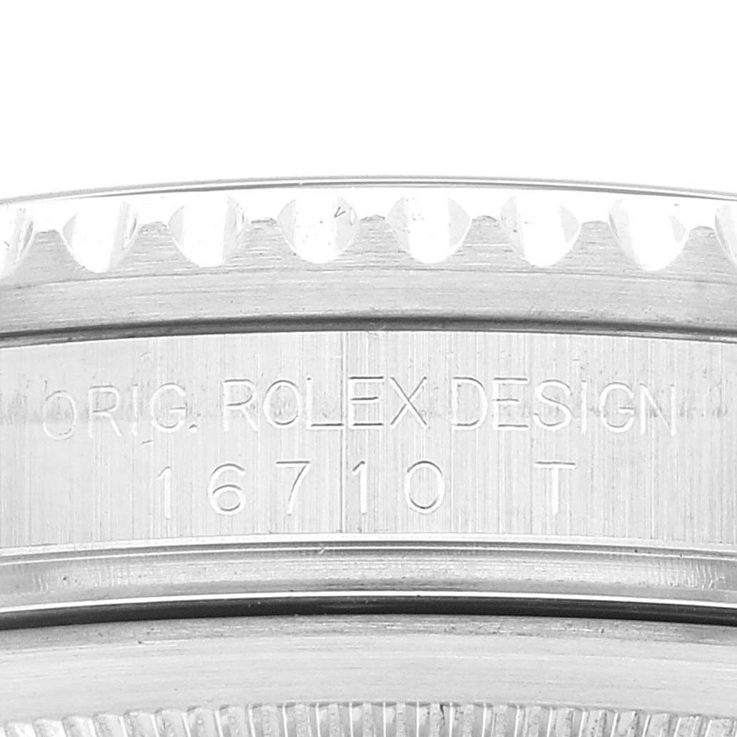 The image shows a close-up of the side casing of a Rolex GMT-Master 16710 Men's Stainless Steel Black Dial 16710 Men's Stainless Steel Black Dial model, featuring its engraved design number 16710.