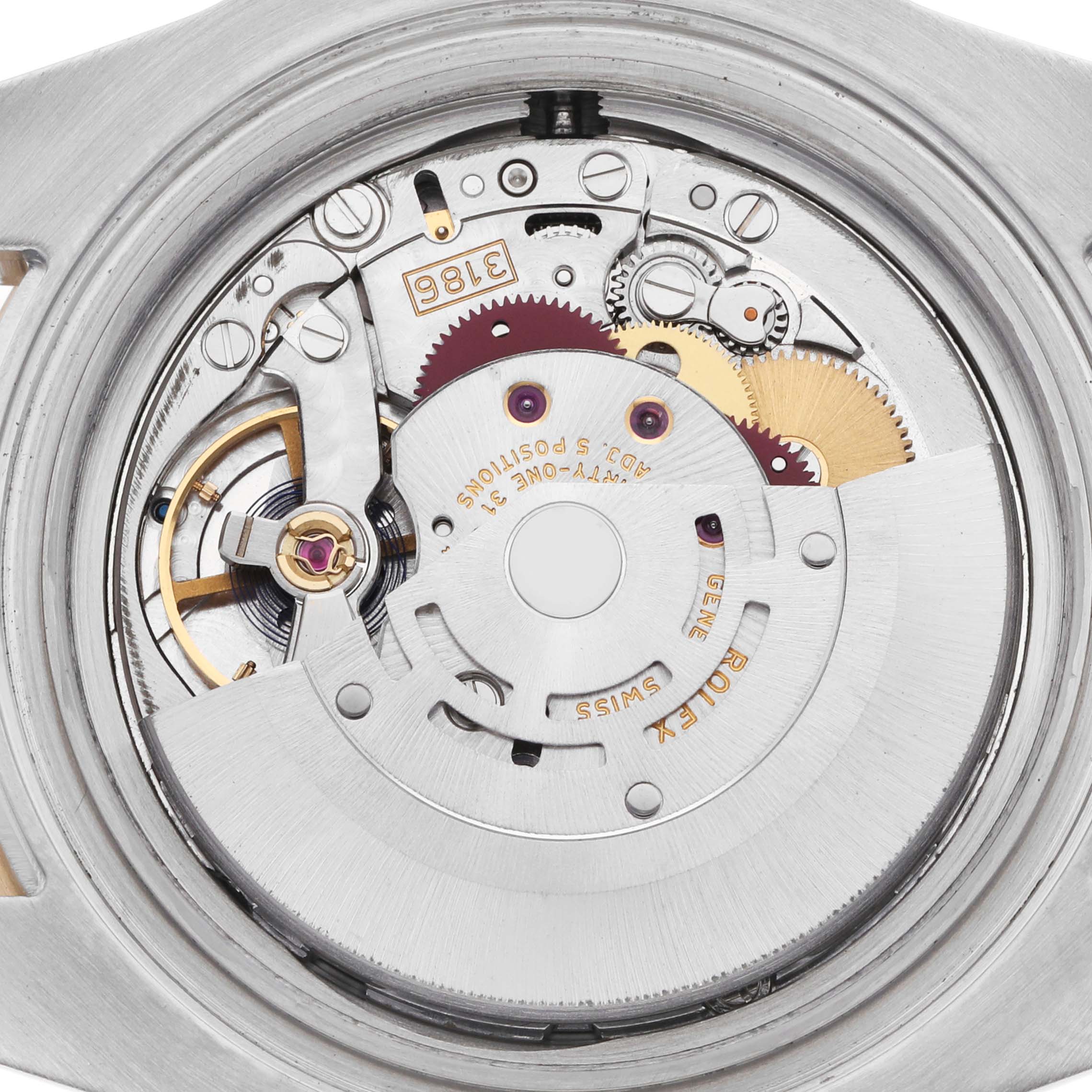 The image shows the intricate inner workings of a Rolex GMT-Master 116713 Men
s Steel and Gold (two tone) Black Dial, highlighting the movement and gears.