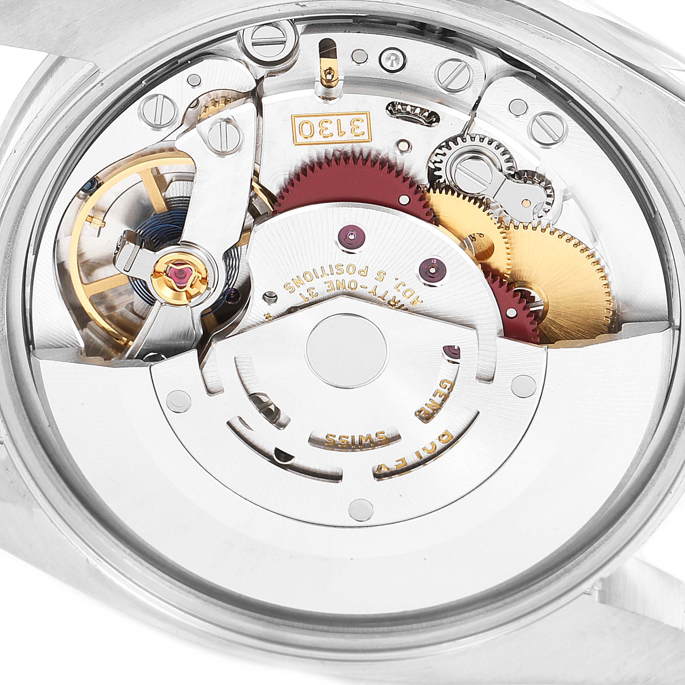 This is a close-up view of the movement mechanism of a Rolex Oyster Perpetual 114200 Men's Stainless Steel Champagne Dial 114200 Men's Stainless Steel Champagne Dial watch.