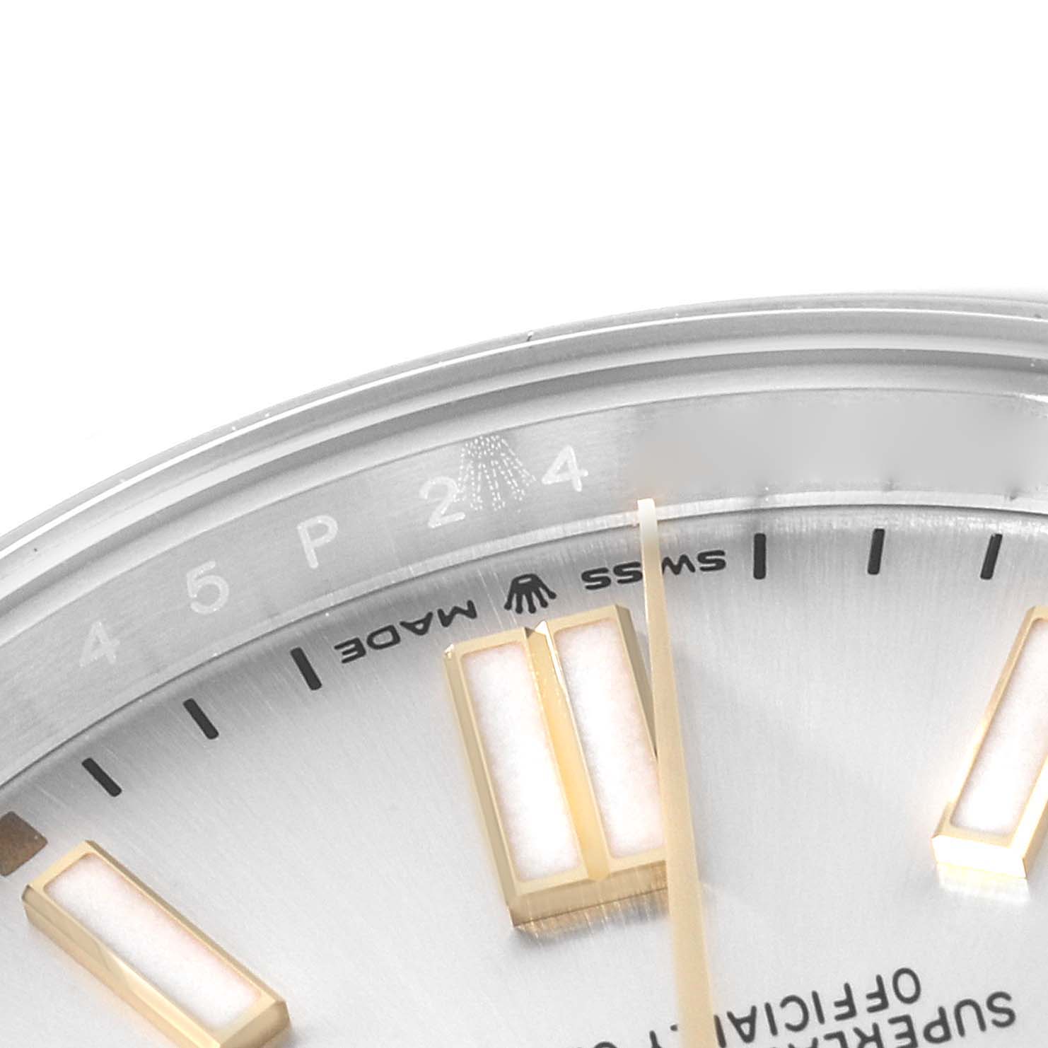 This is a close-up of a Rolex Oyster Perpetual 124300 Men's Stainless Steel Silver Dial 124300 Men's Stainless Steel Silver Dial's dial and the inner bezel with some minute markers visible.