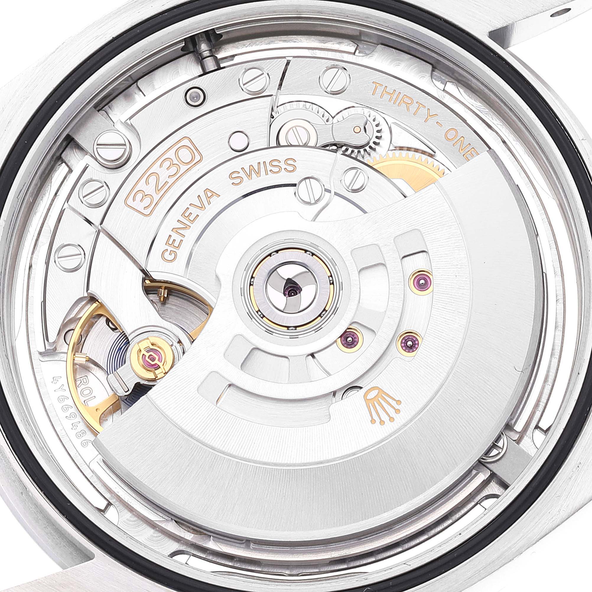 This is a close-up shot of the movement inside a Rolex Oyster Perpetual 124300 Men's Stainless Steel Silver Dial 124300 Men's Stainless Steel Silver Dial watch, displaying the intricate mechanisms and engravings.