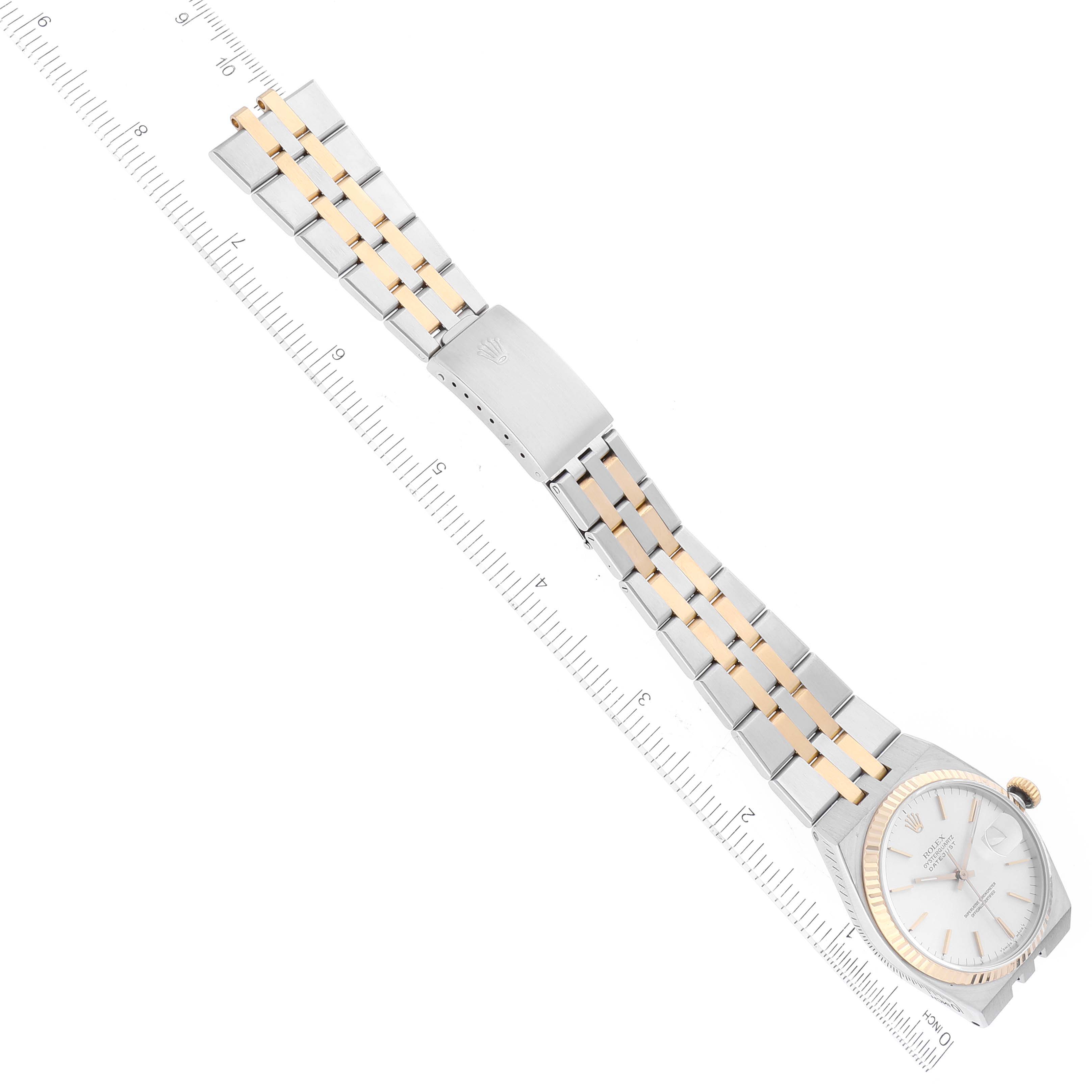 The image shows a Rolex Oysterquartz 17013 Men
s Stainless Steel Silver Dial 17013 Men
s Stainless Steel Silver Dial watch at a diagonal angle, highlighting the watch face, gold bezel, and two-tone metal bracelet.