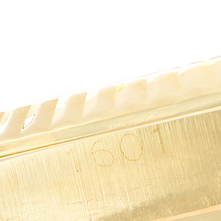This is a close-up angle showing the serial number inscribed on the gold casing of the Rolex Vintage Collection 1601 Men's Yellow Gold Black Dial 1601 Men's Yellow Gold Black Dial model 1601.