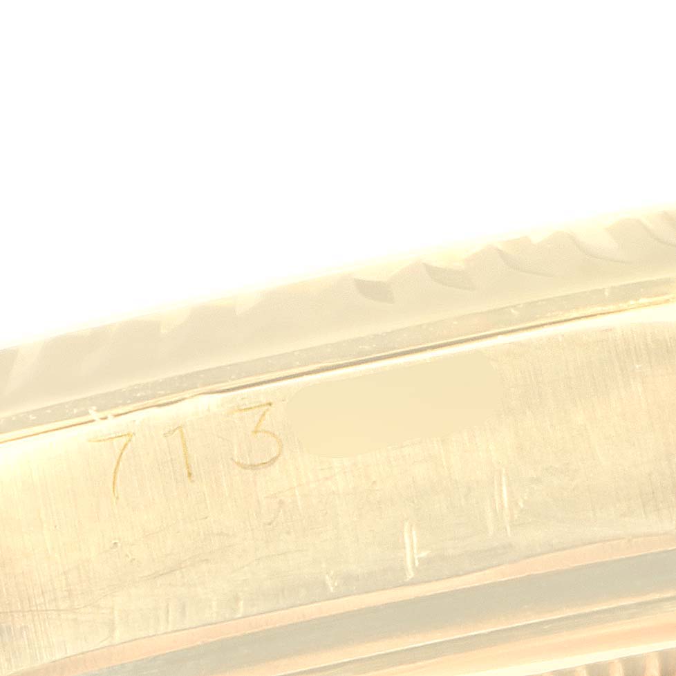 This image shows a close-up view of the engraved serial number on the case of the Vintage Collection model by Rolex.