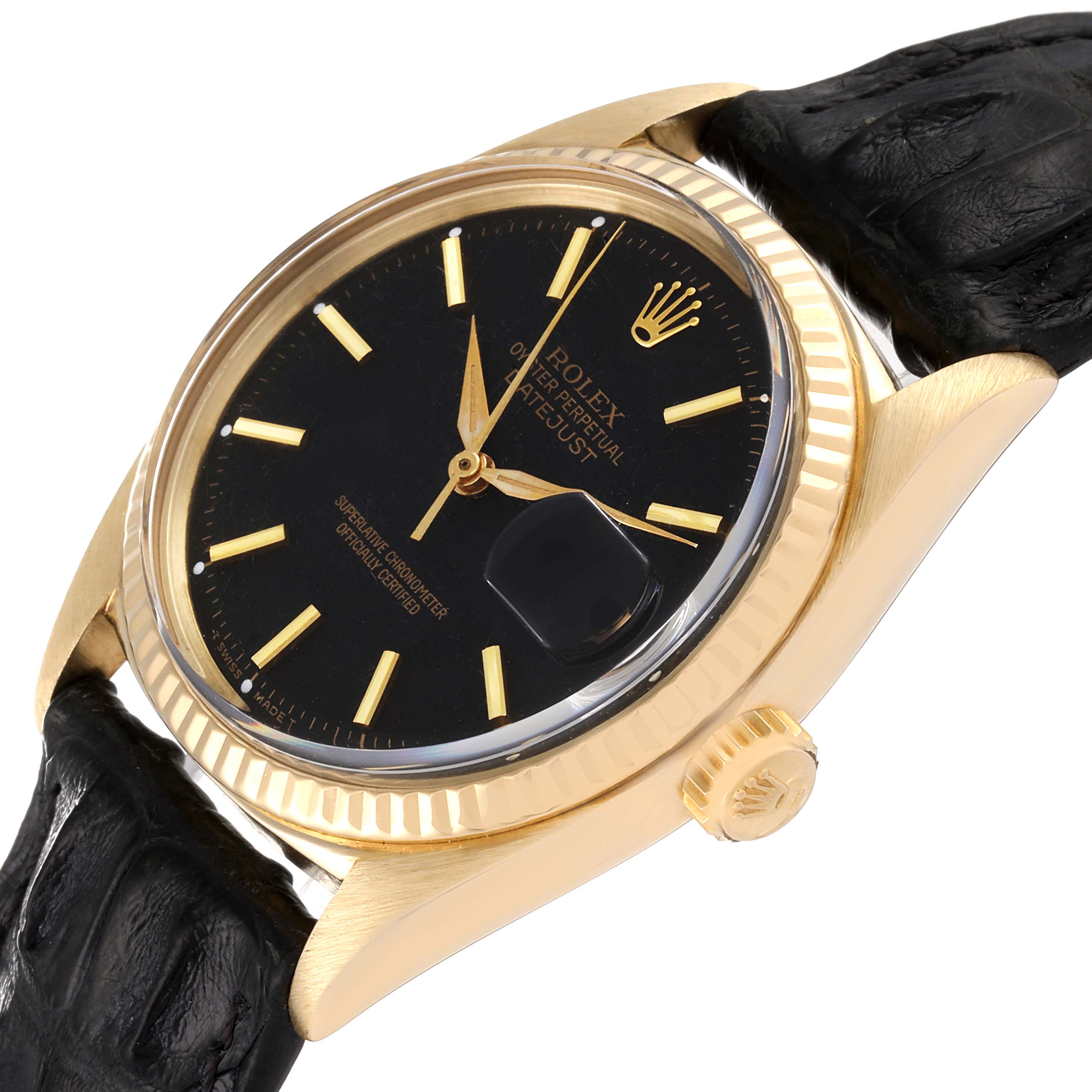 This image shows a tilted view of the Rolex Vintage Collection 1601 Men's Yellow Gold Black Dial 1601 Men's Yellow Gold Black Dial watch, displaying the bezel, crown, face, and part of the leather strap.