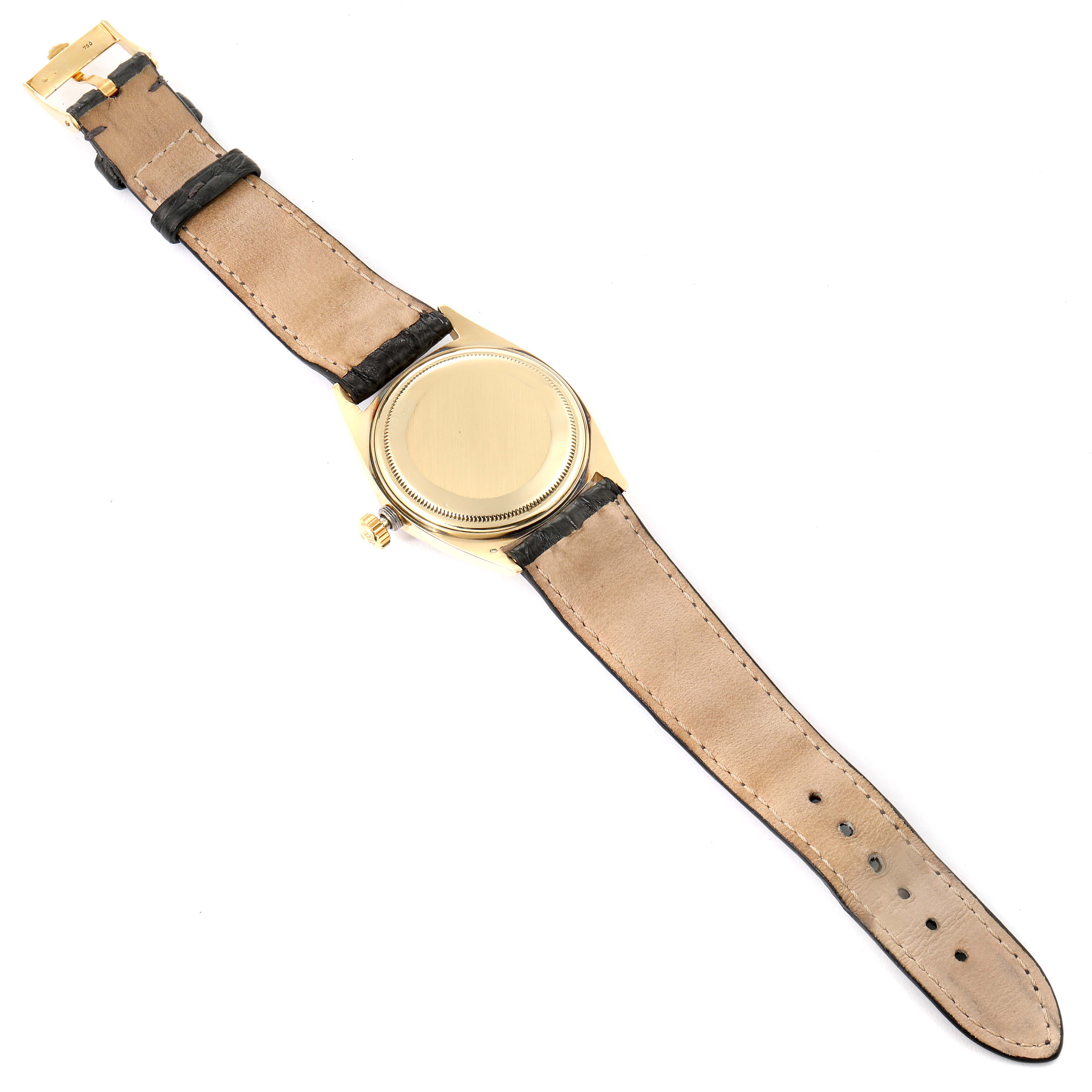 This image shows the back view of a Rolex Vintage Collection 1601 Men's Yellow Gold Black Dial 1601 Men's Yellow Gold Black Dial model watch, highlighting its strap and case back.