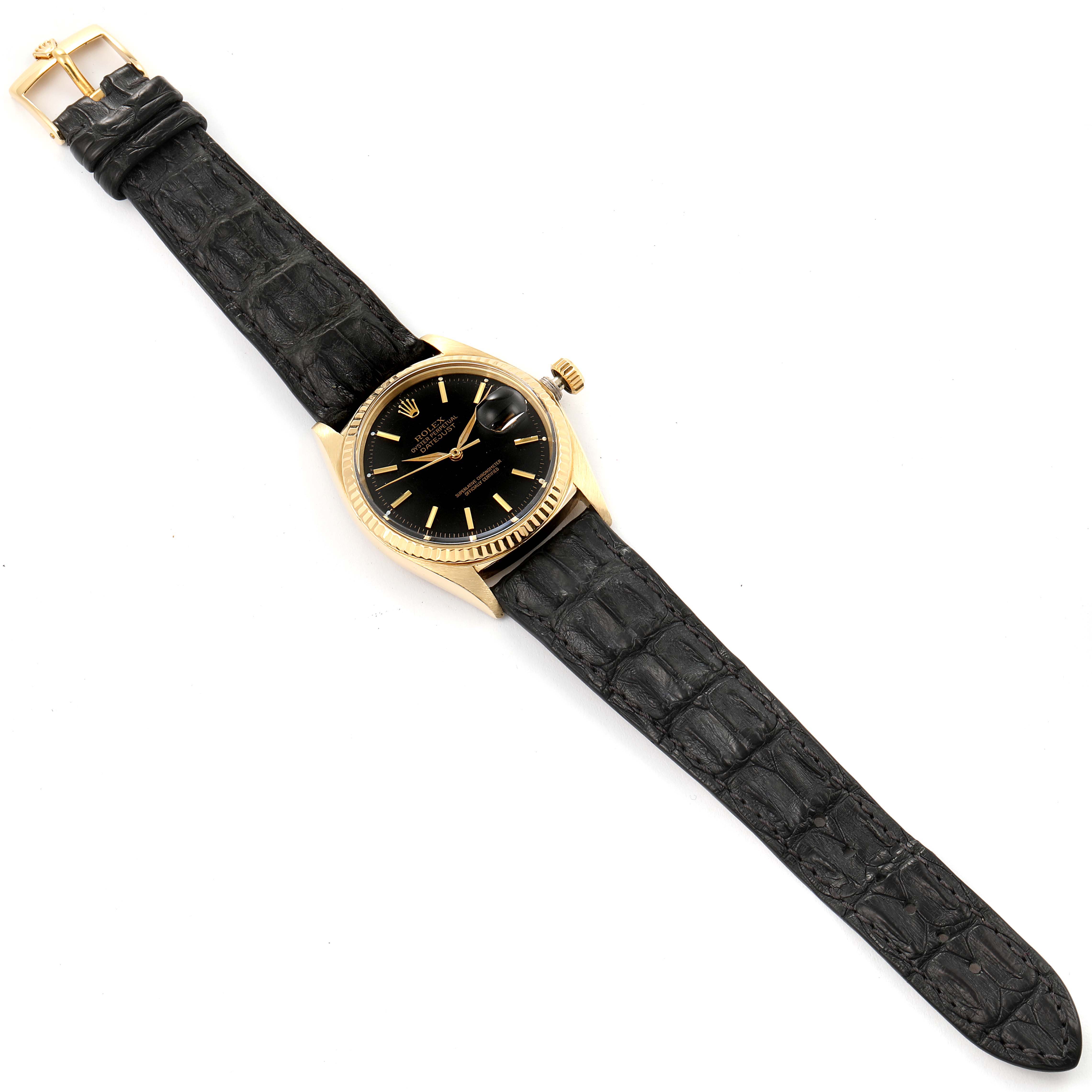 The Rolex Vintage Collection 1601 Men's Yellow Gold Black Dial 1601 Men's Yellow Gold Black Dial model watch is shown from a top-down angle, featuring a black leather strap and gold case with a black dial.
